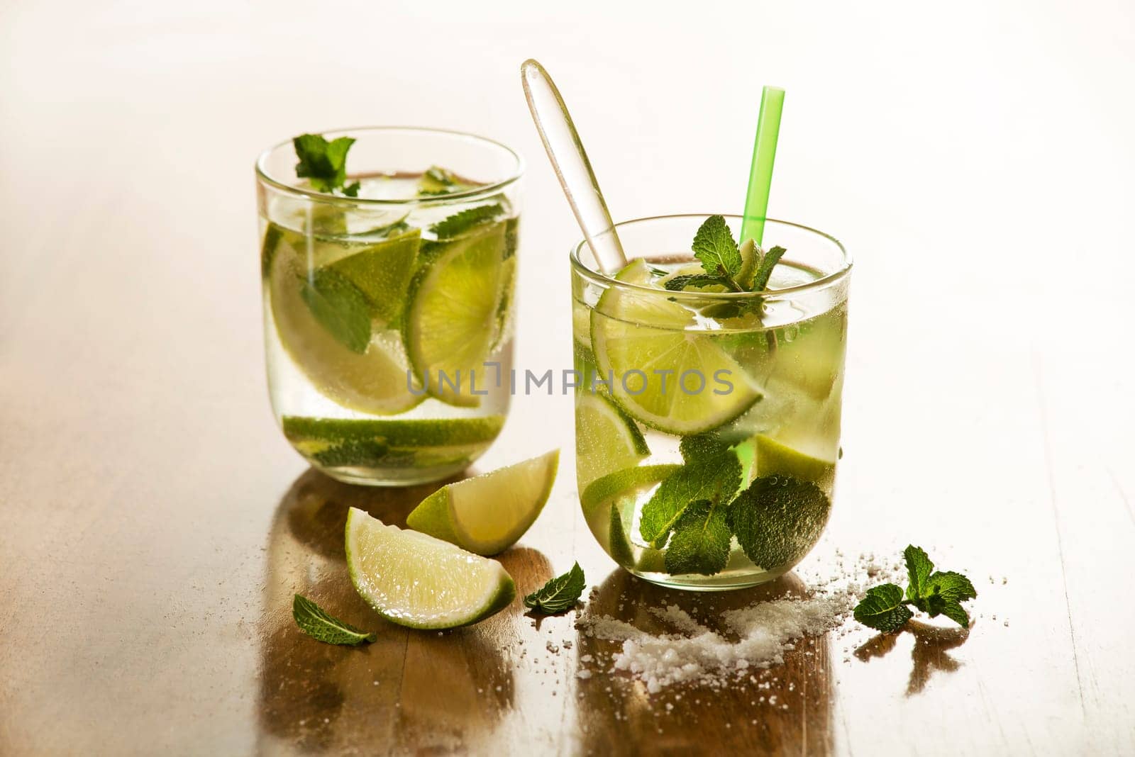 Cold Mojito cocktail on a rustic table close up.