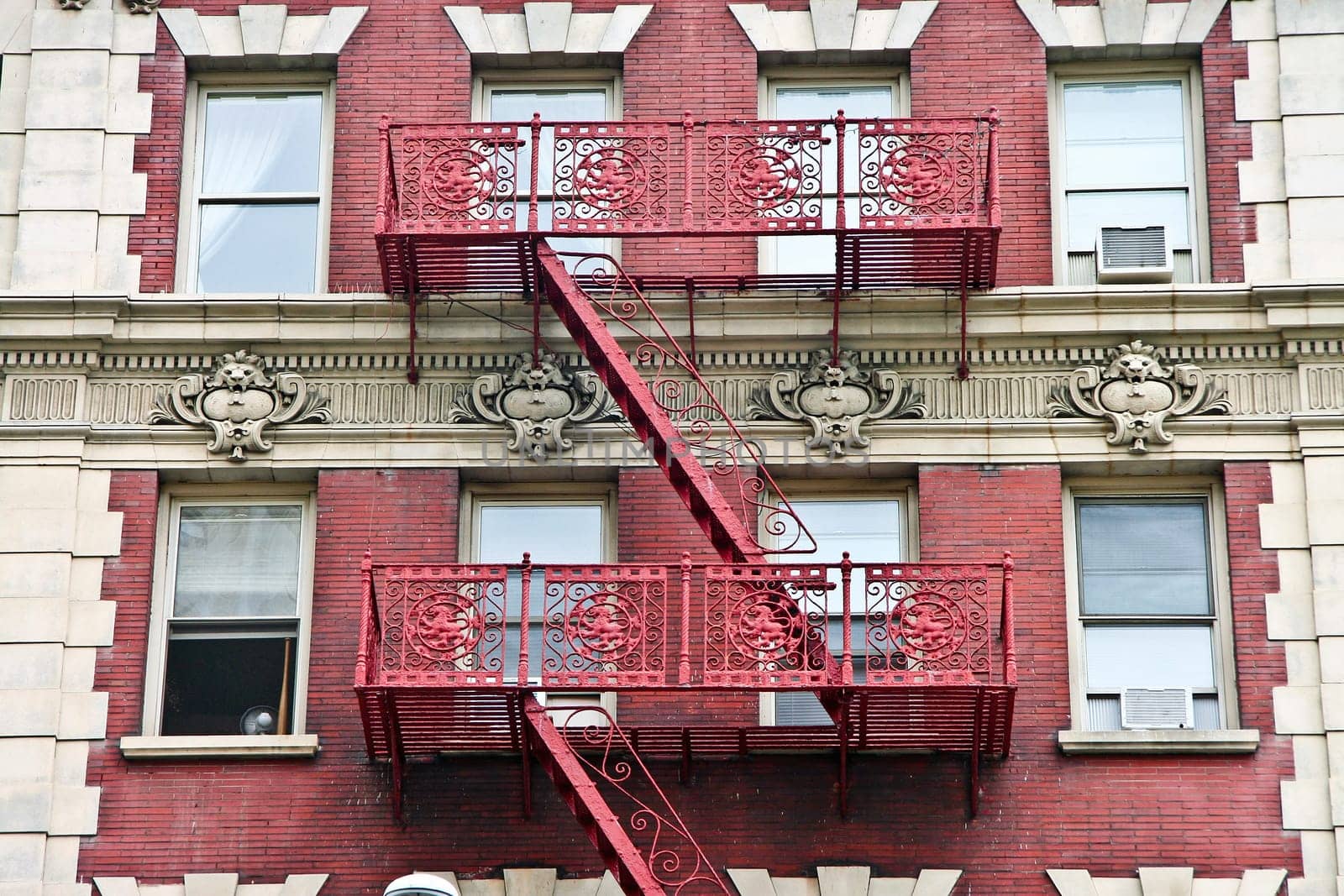 Ornate Harlem apartment building with extensive fire escapes