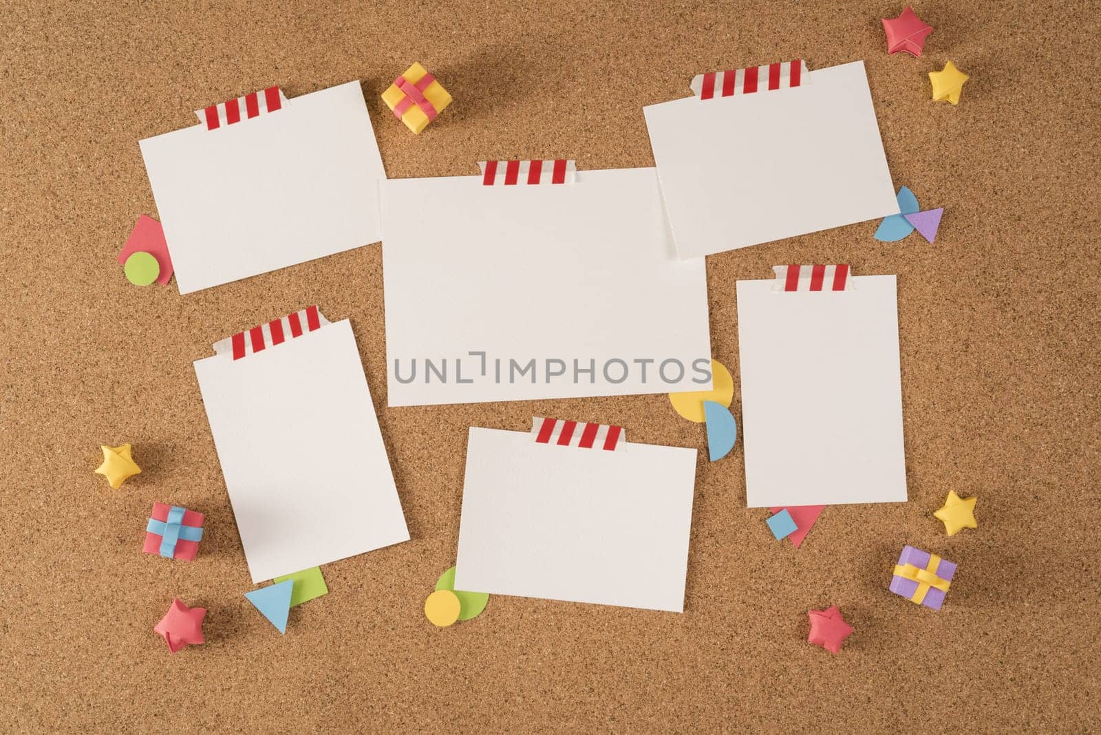 Set of blank paper template notes taped on cork notice board with colorful handmade elements. Includes clipping path mock up for design your own portfolio, school, office or stationery...