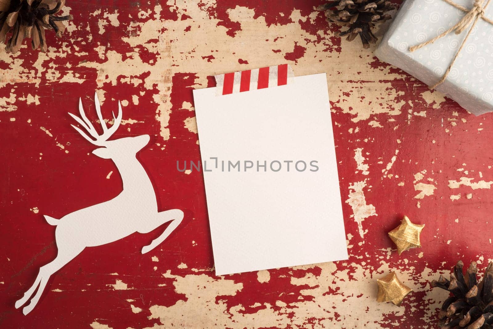 Merry Christmas greeting card top view template on hipster grunge wood texture background with reindeer paper shape and holiday decoration.   .