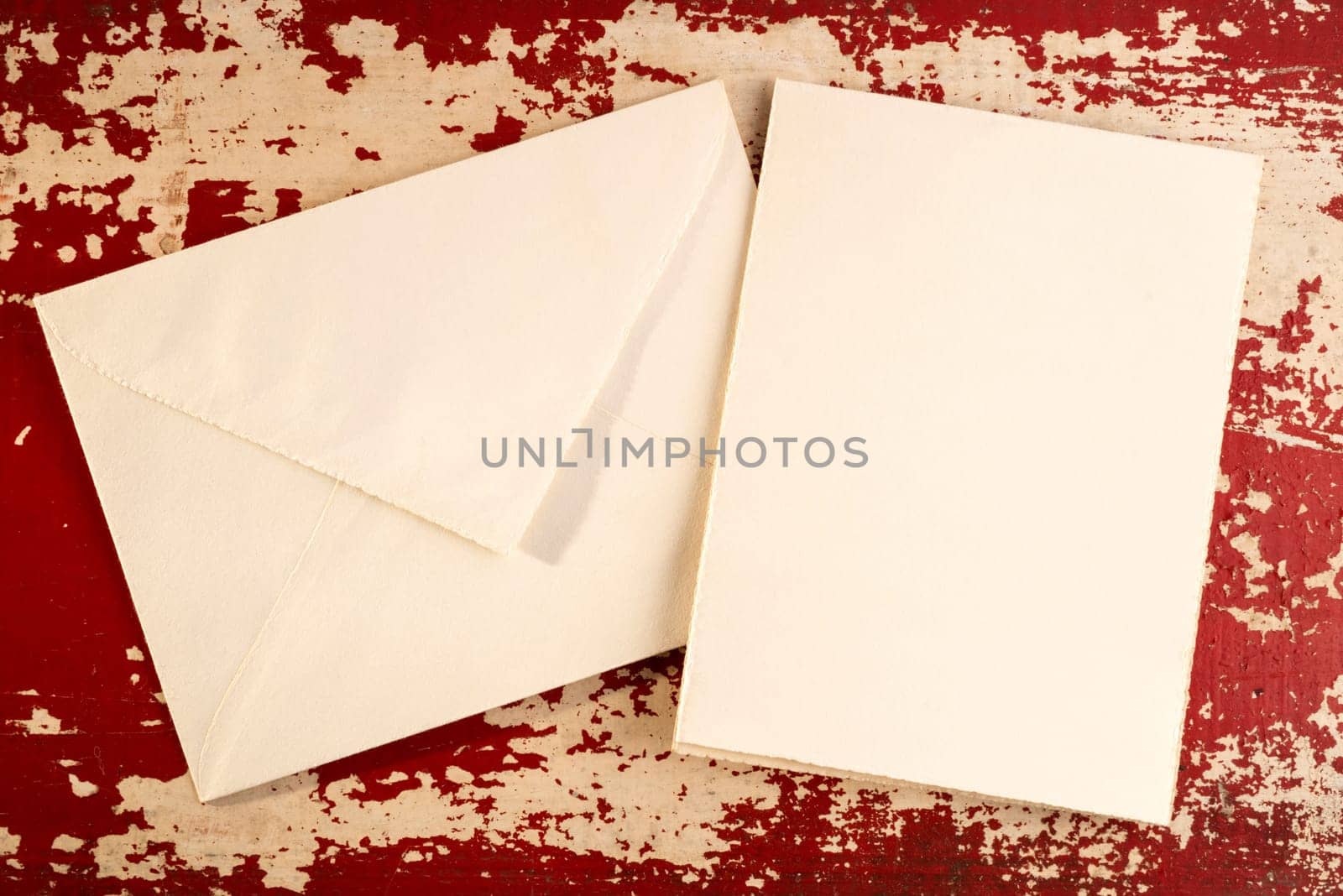 Vintage greeting card top view concept template with paper envelope on grunge wood texture background. Includes clipping path.