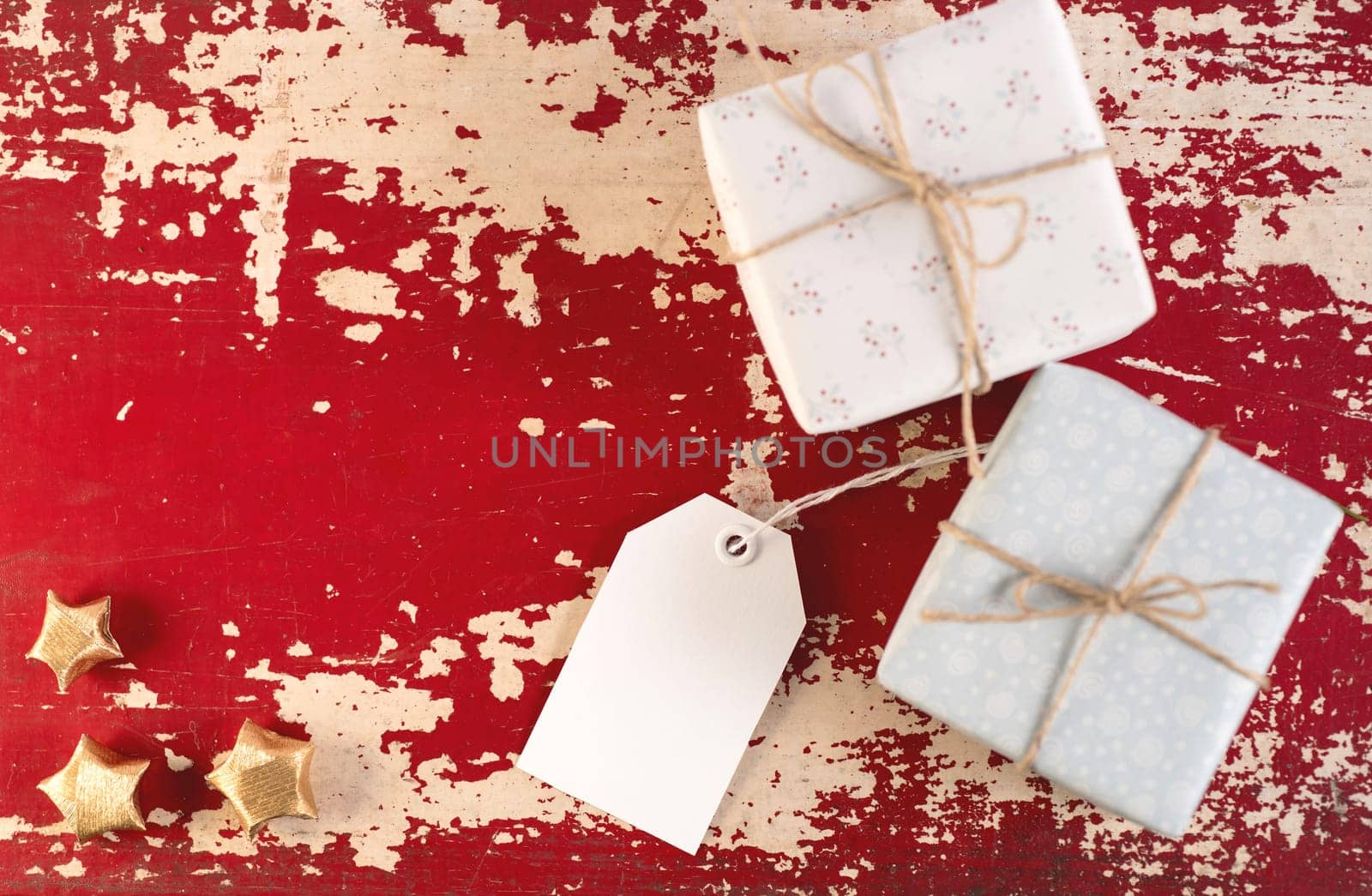 Christmas top view concept label template with vintage gift boxes and decoration on hipster wood texture background. Includes clipping path for tag.