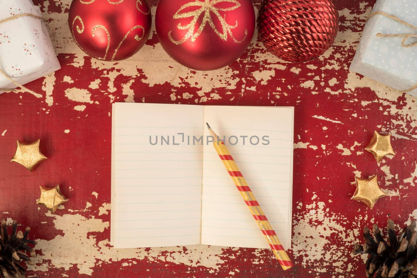 Christmas card background, top view notebook template with pencil and vintage holiday decoration ornaments on hipster grunge wood texture.