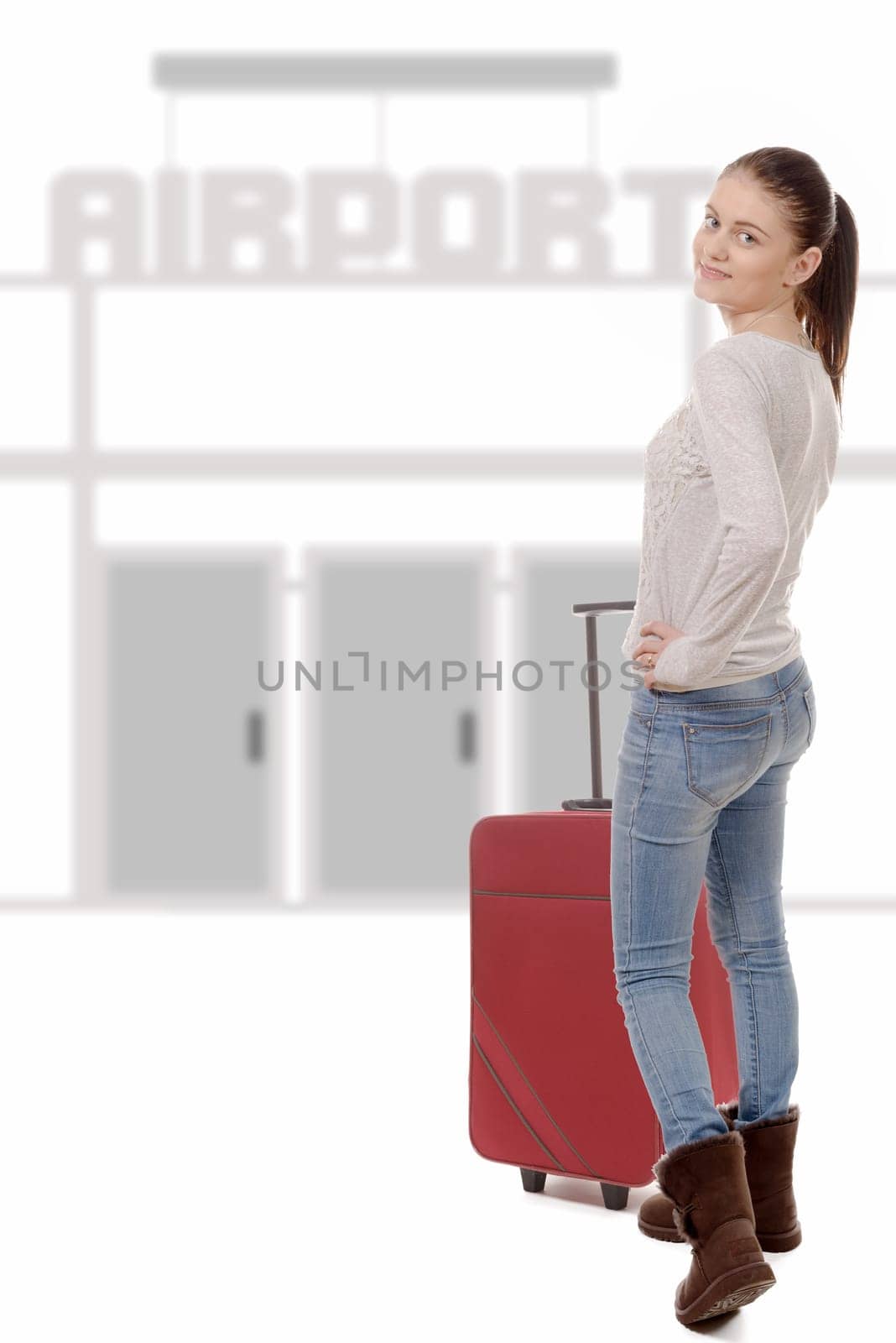a young woman with her suitcase goes to the airport