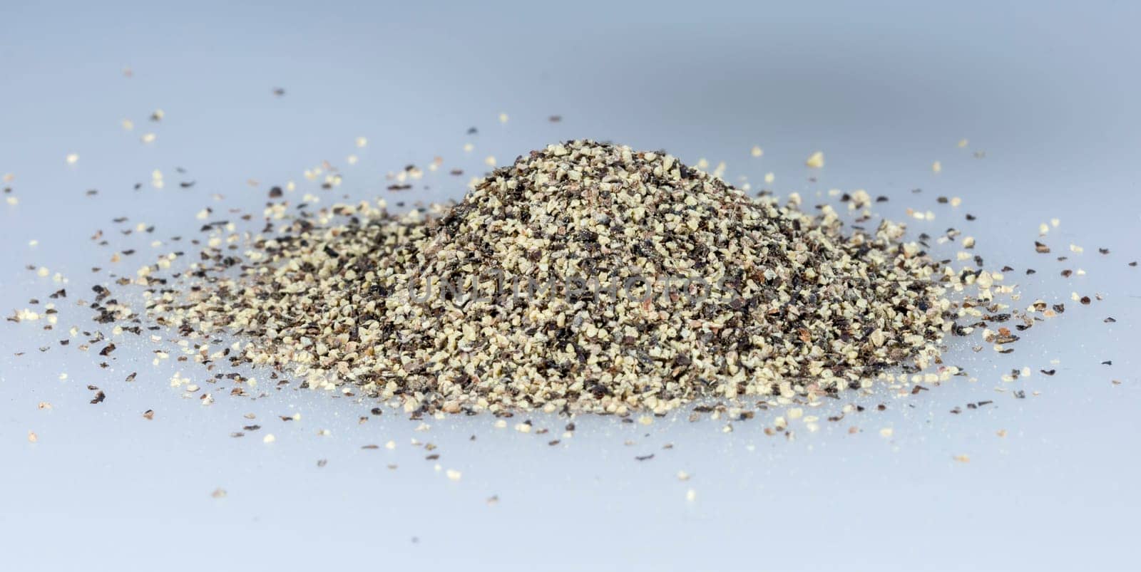 Black Pepper Grains in a pile close up.