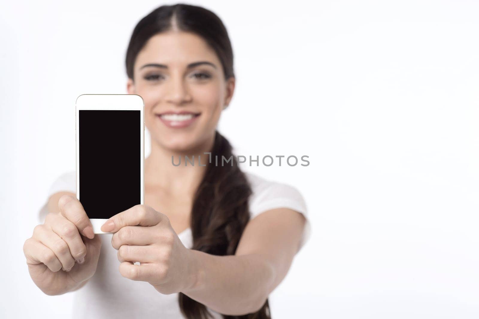 Young woman taking her own picture with her new phone