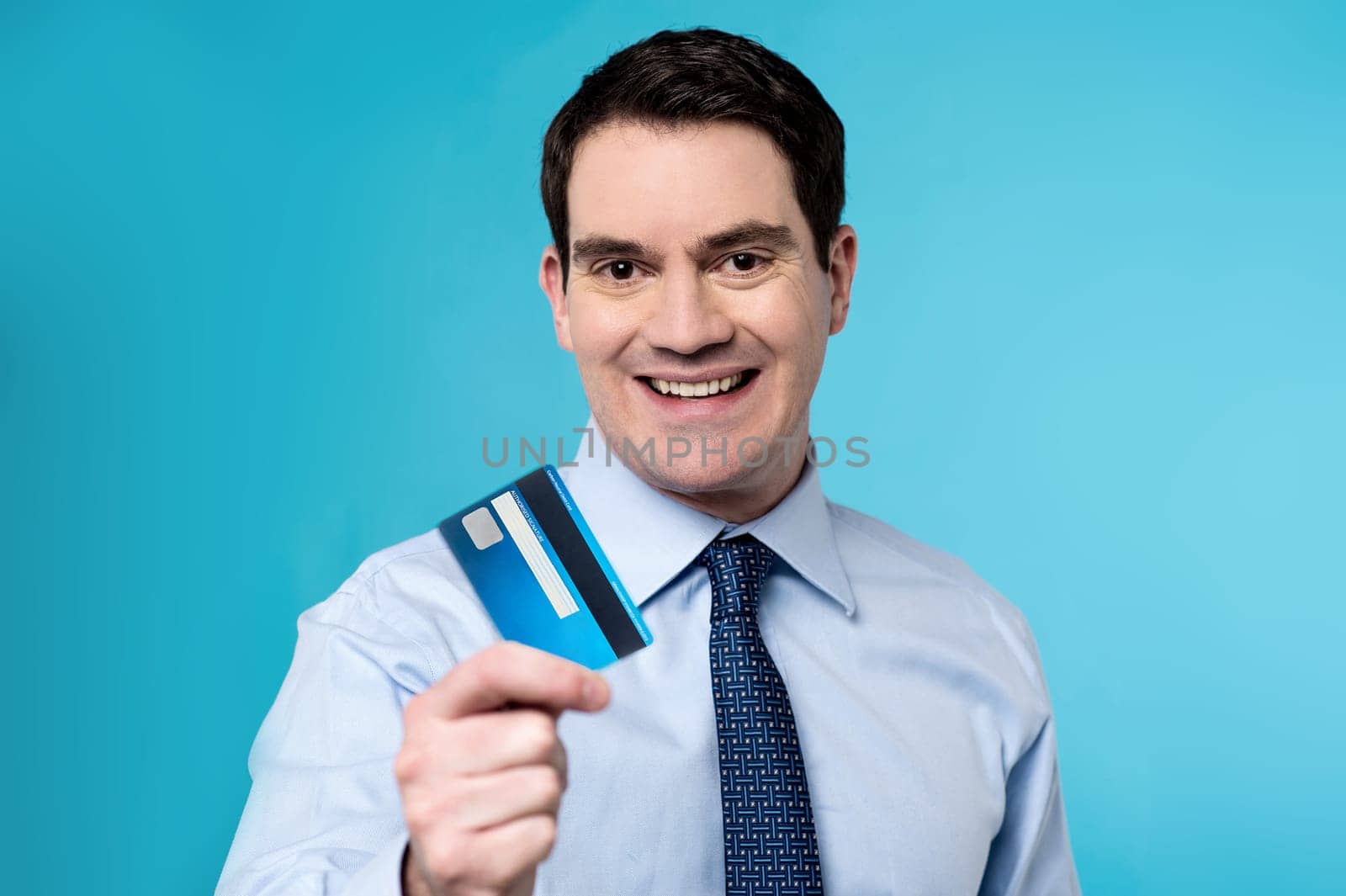 Middle aged man lending his plastic card to camera