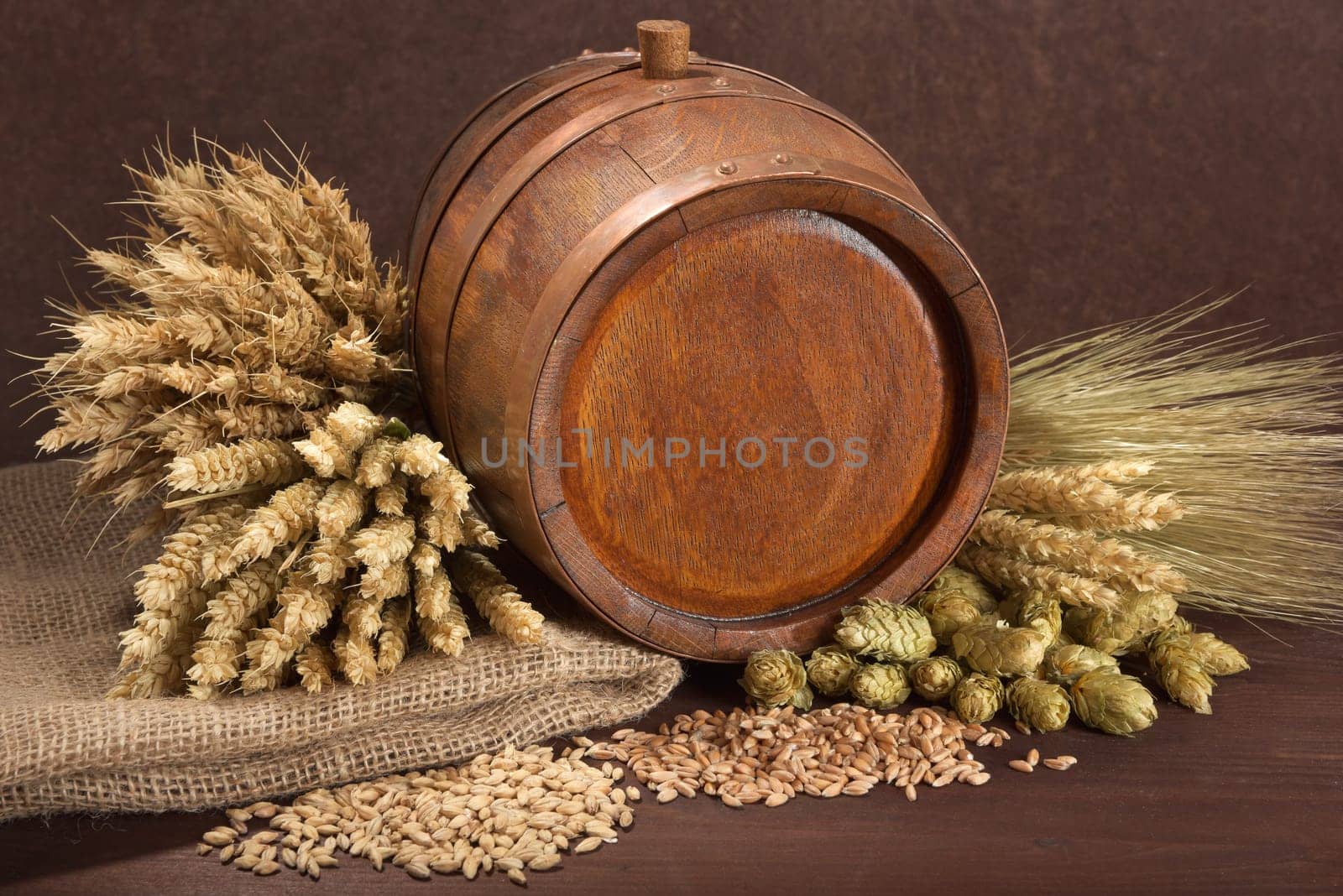Old barrel with wheat,barley,hops and malt