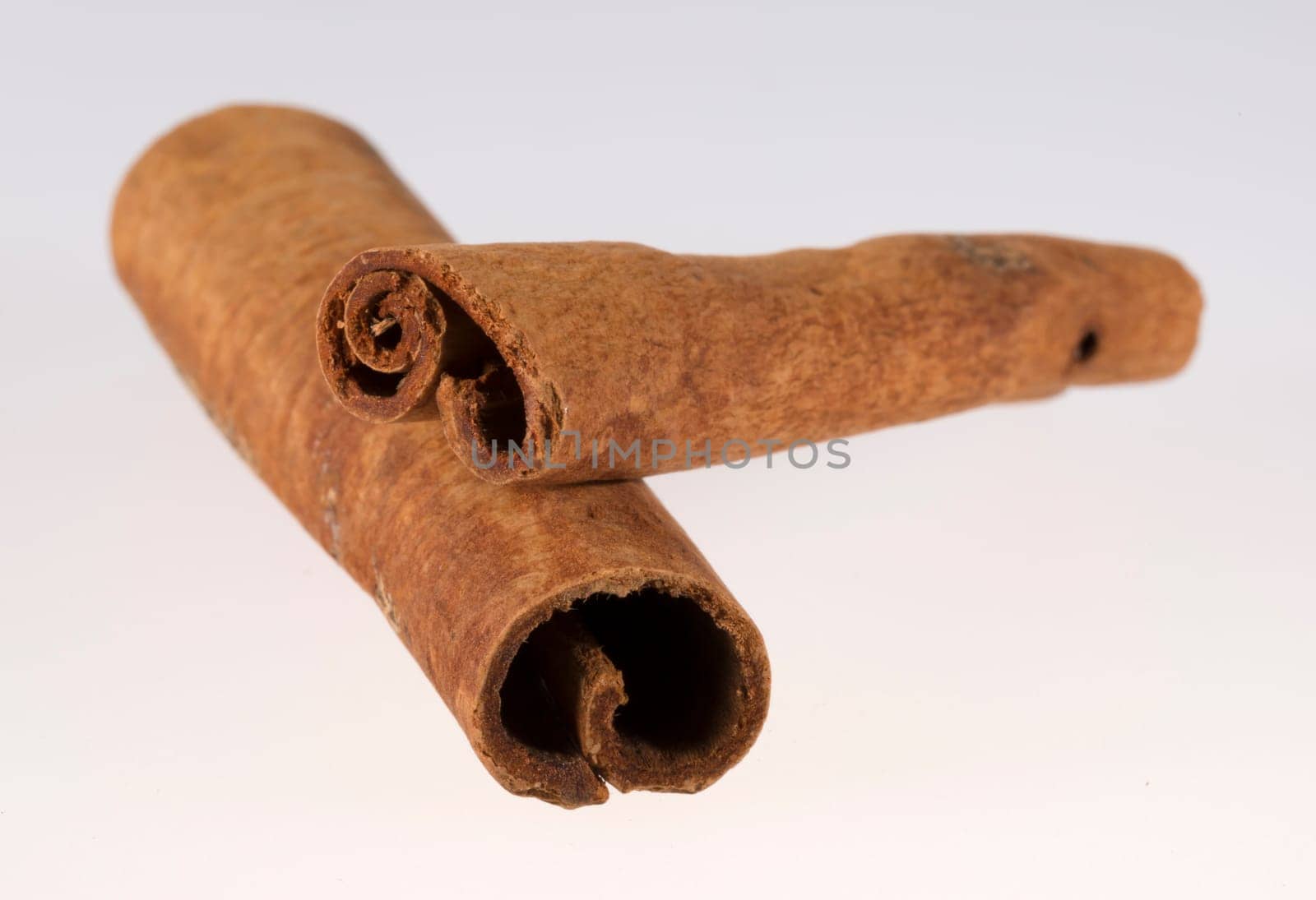 Stacked Cinnamon Sticks close up on a white background.