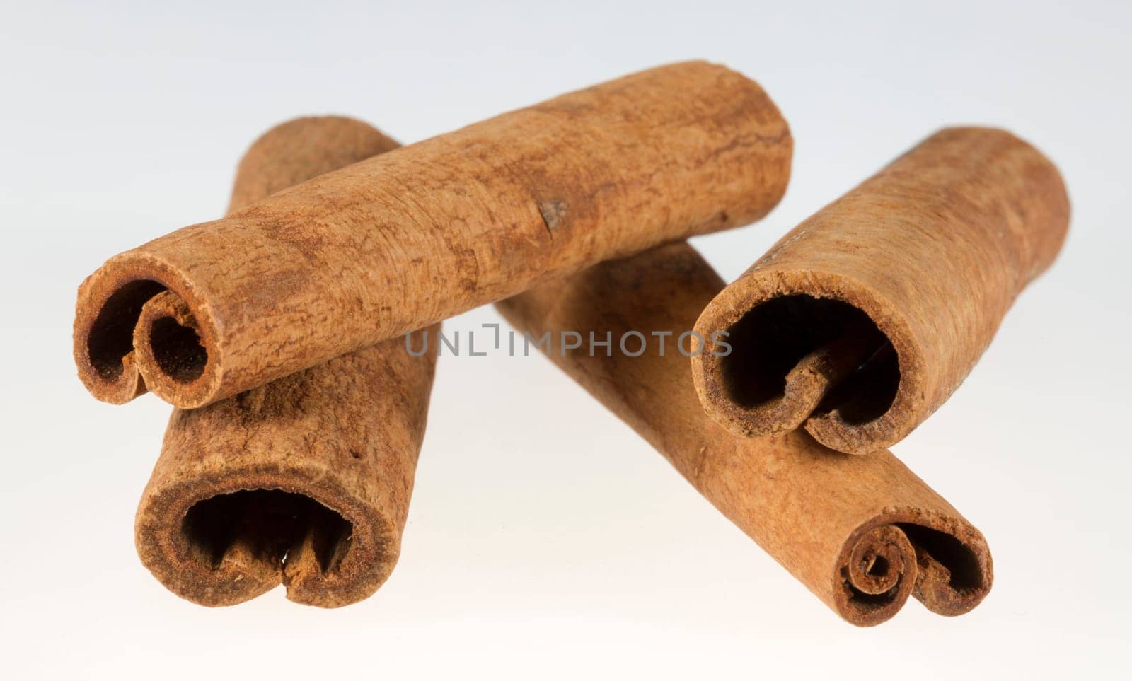 Stacked Cinnamon Sticks close up on a white background.