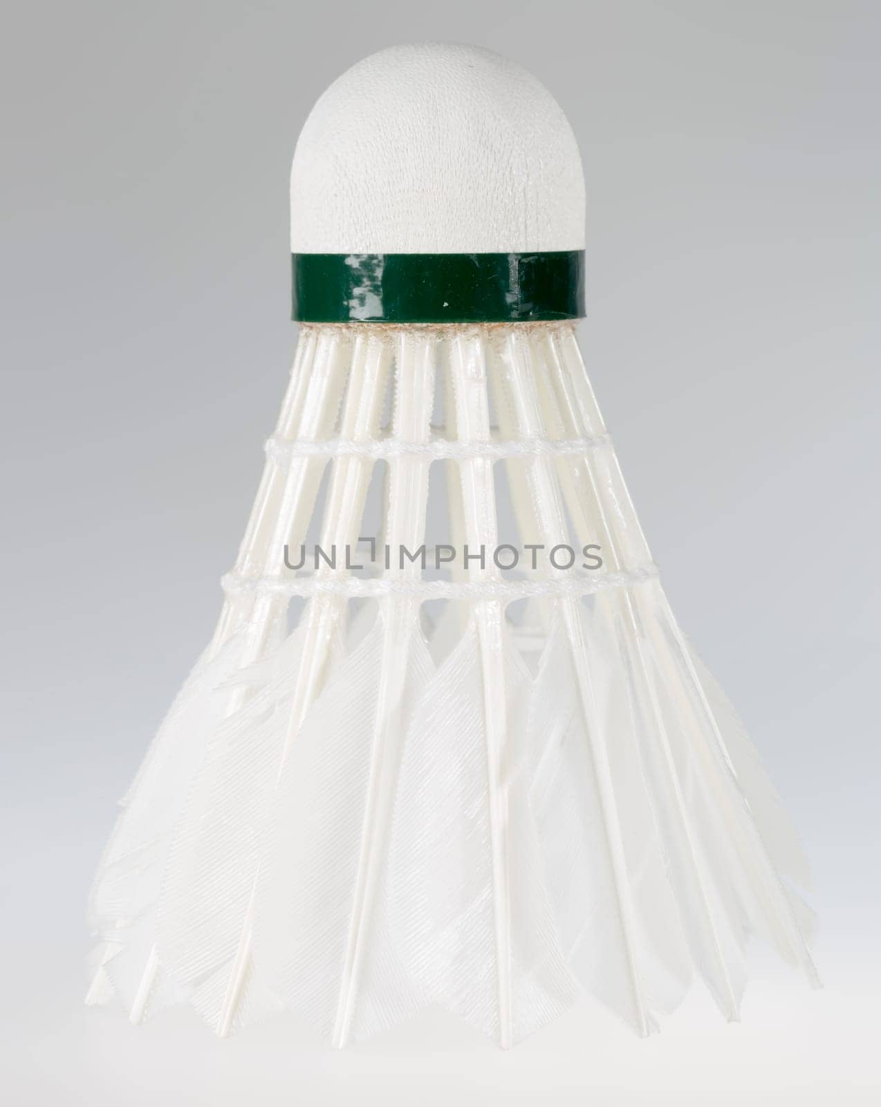 Feathered White Shuttlecock with grey background. Macro image.
