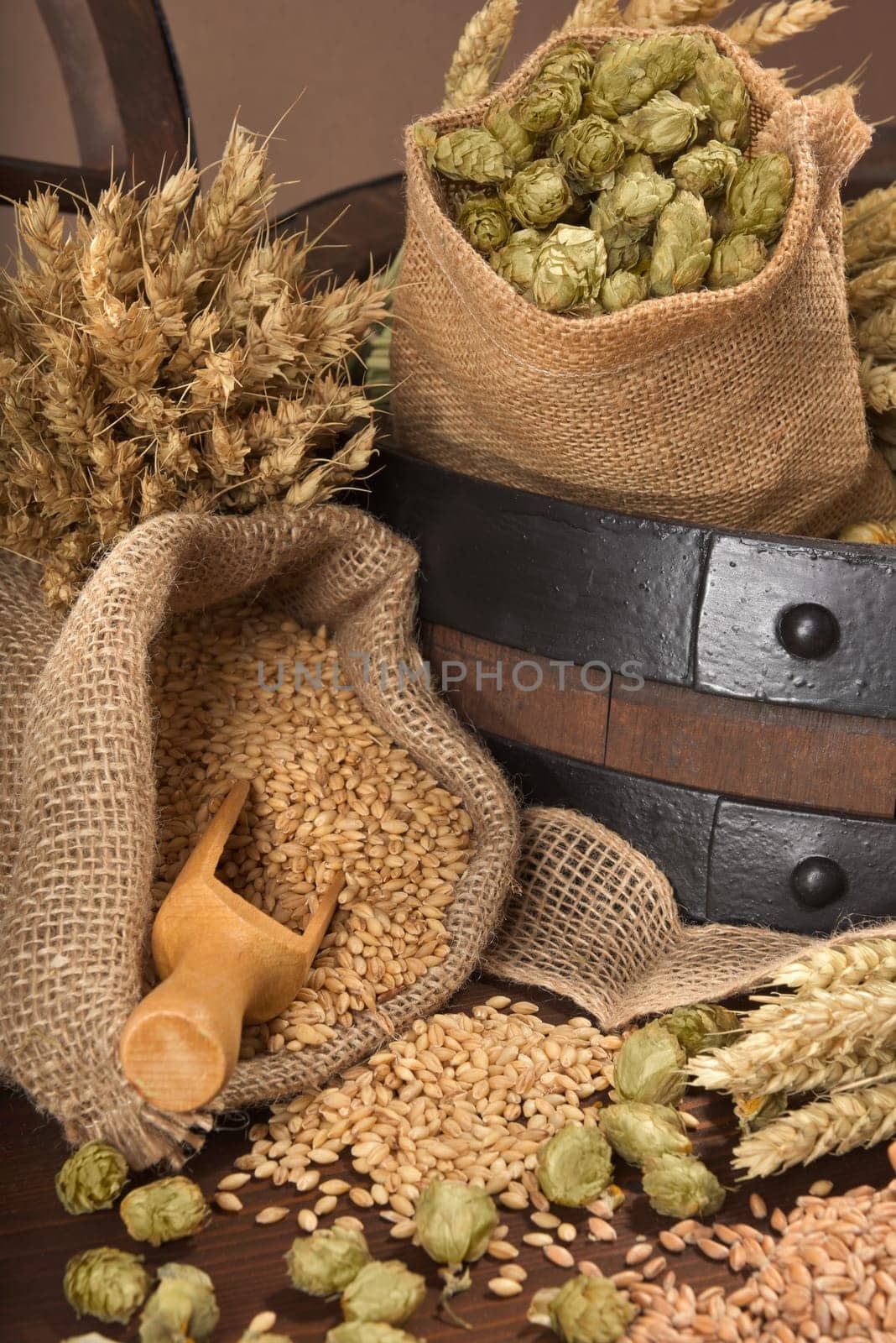 Beer barrel,wagon wheel with wheat,barley,hops and malt