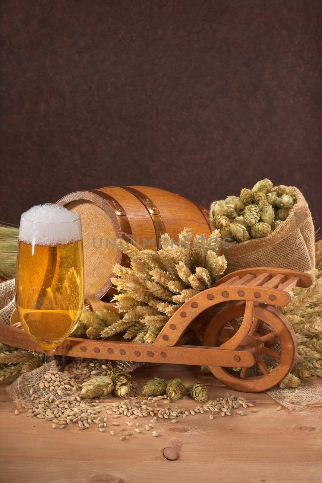 Beer glass with barrel,wheelbarrow,wheat,barley,hops and malt