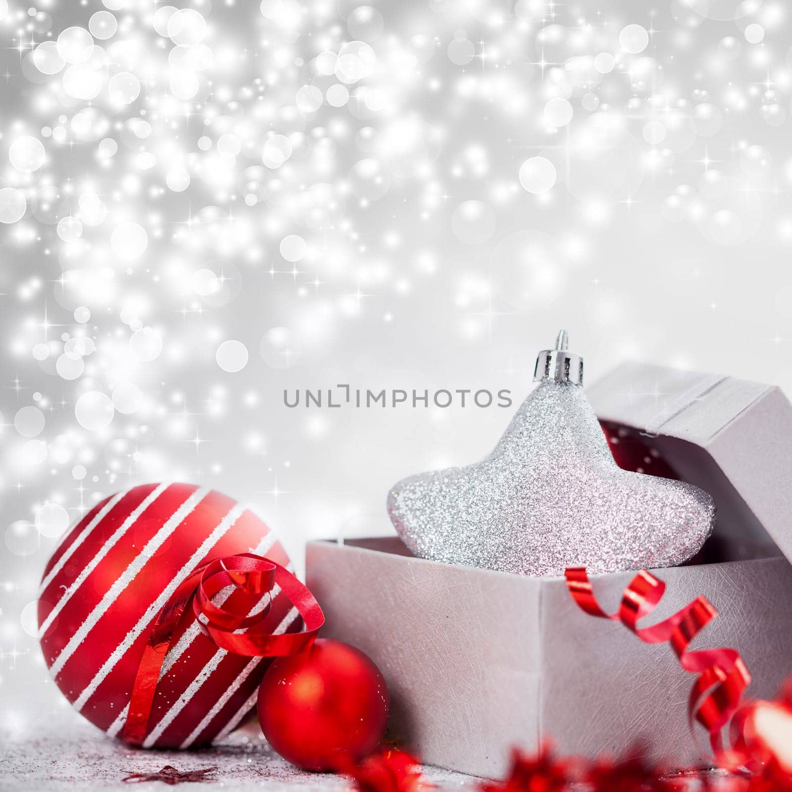 Christmas balls and ornaments in front of glittering background