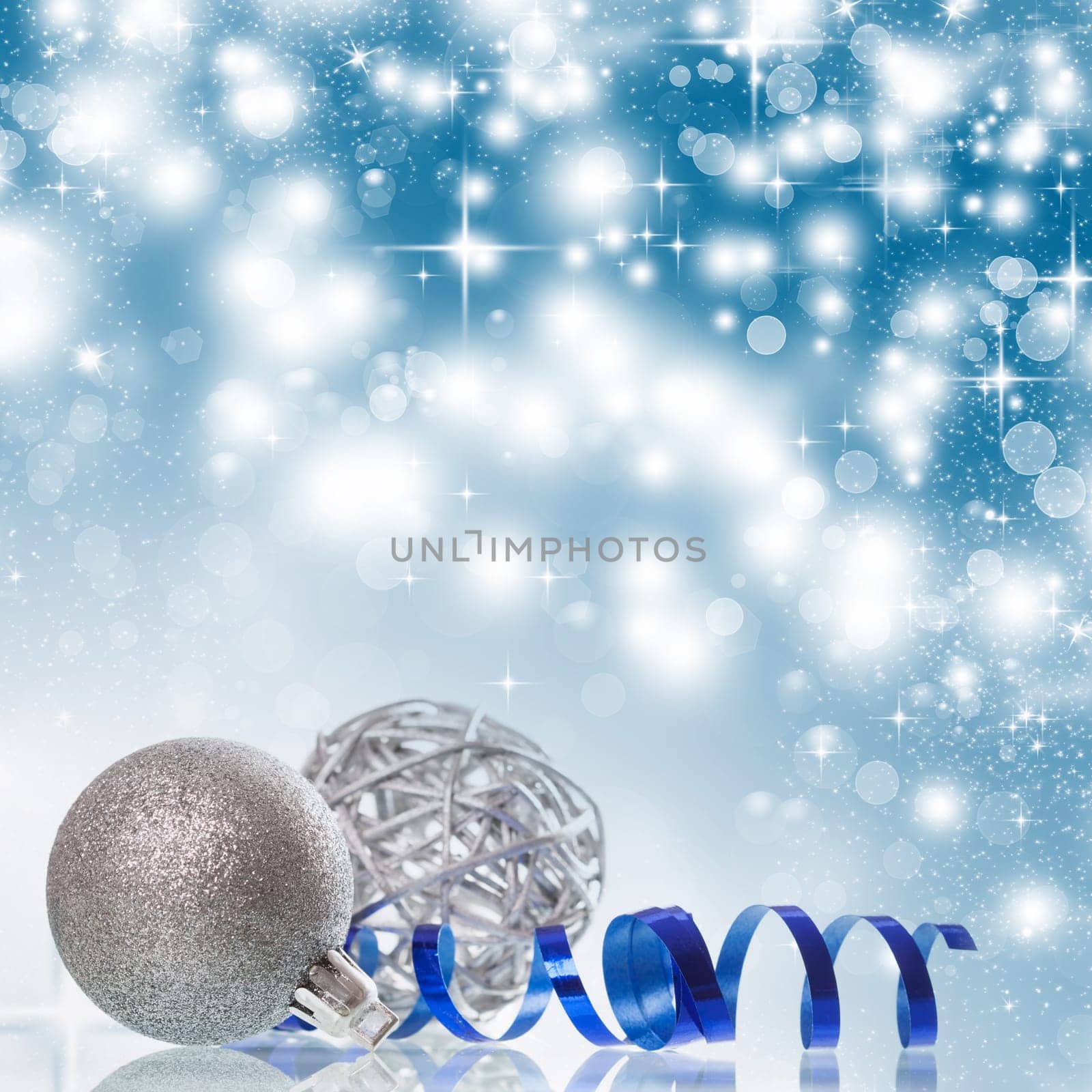 Christmas balls and ornaments in front of glittering background