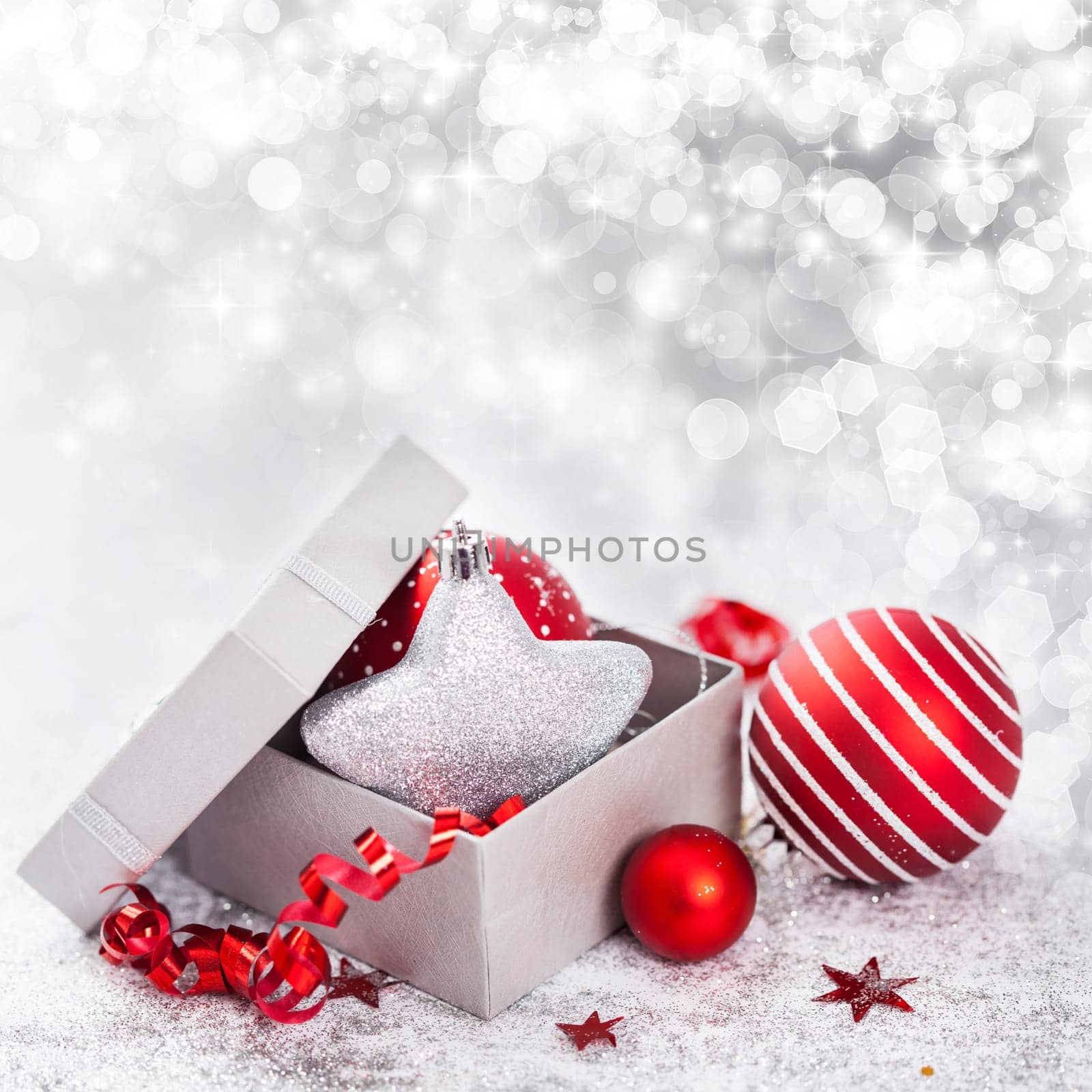Christmas balls and ornaments in front of glittering background
