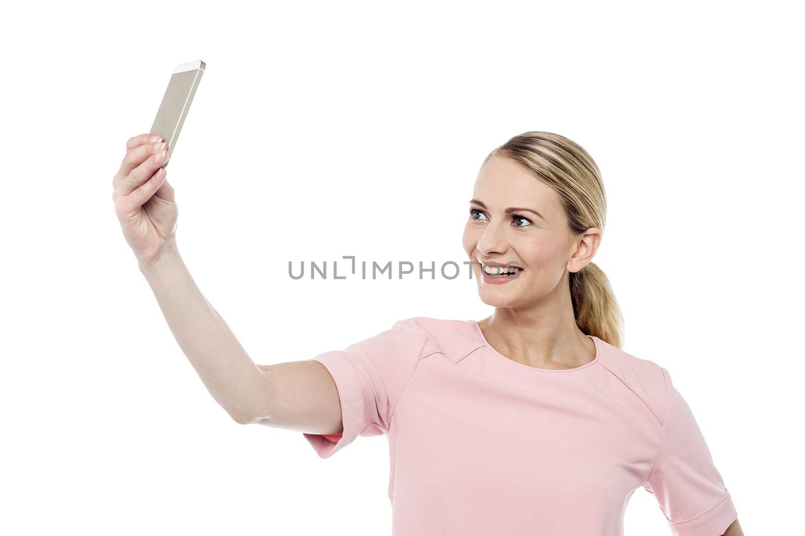 Smiling young woman capturing herself in her phone