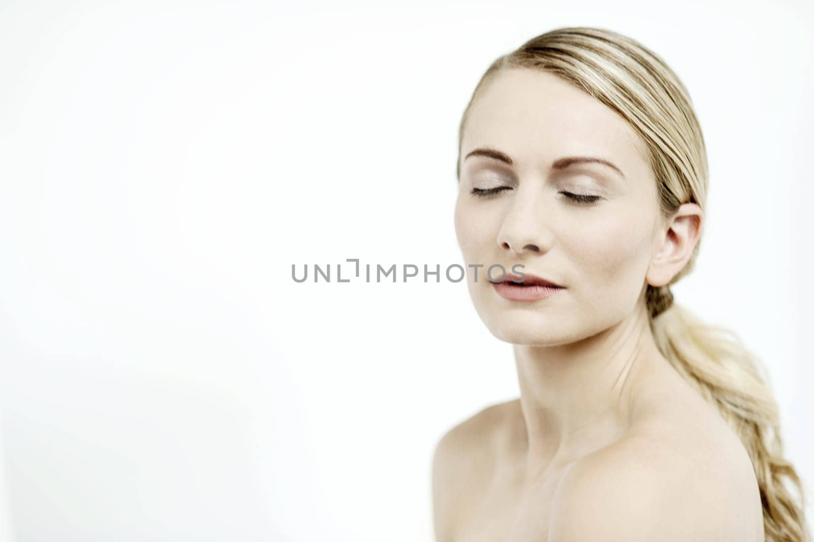 Image of an attractive woman with bare shoulders and closed eyes