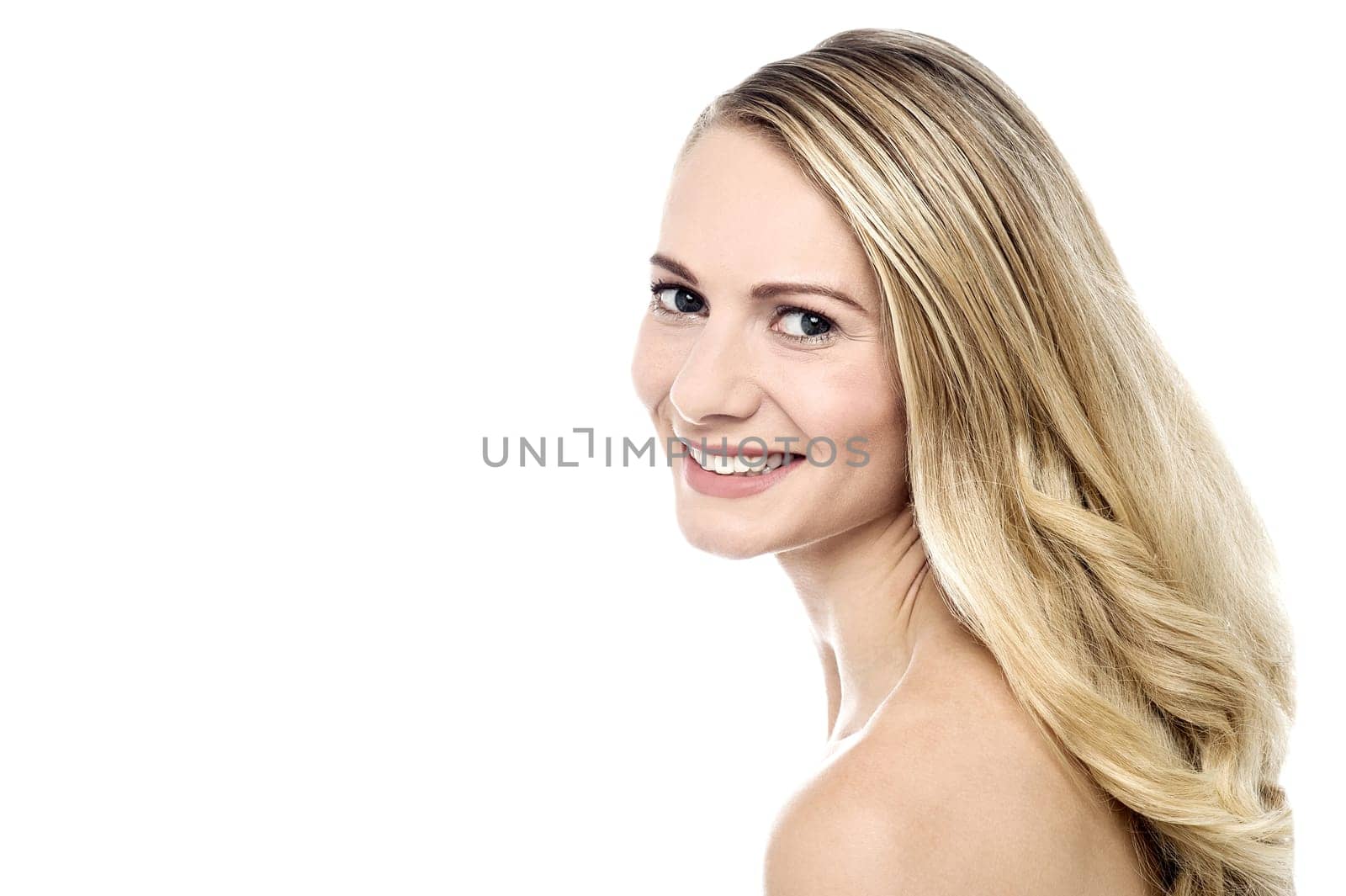 Young happy woman posing sideways over white