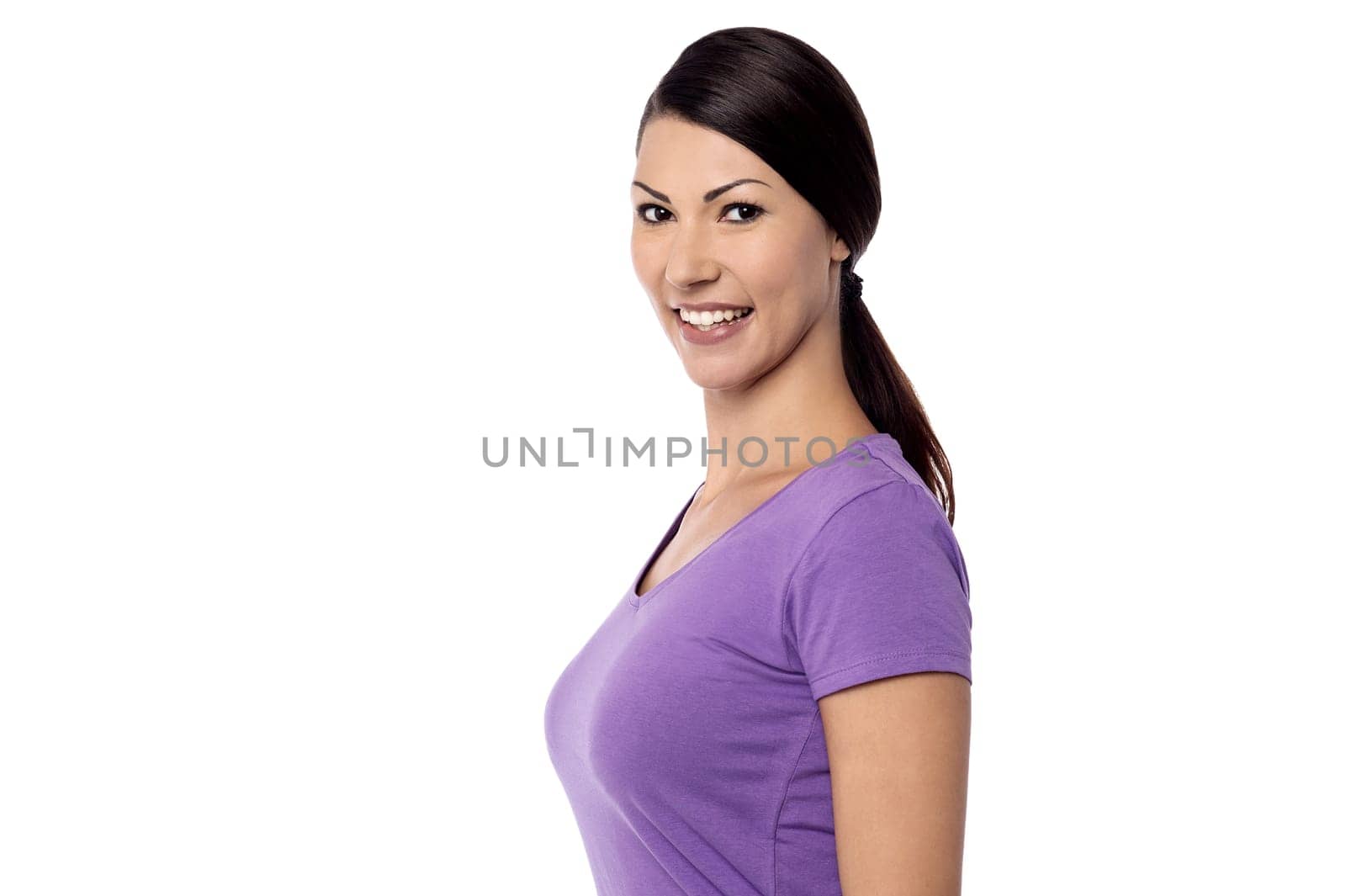 Side pose of a smiling pretty woman looking at camera