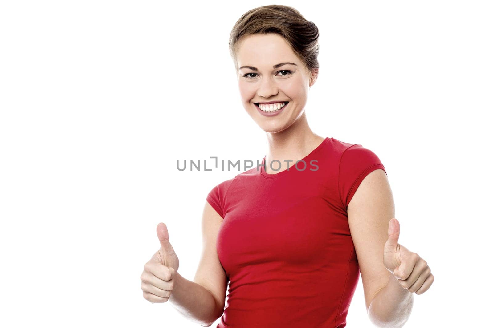 Happy young woman gesturing thumbs up to camera