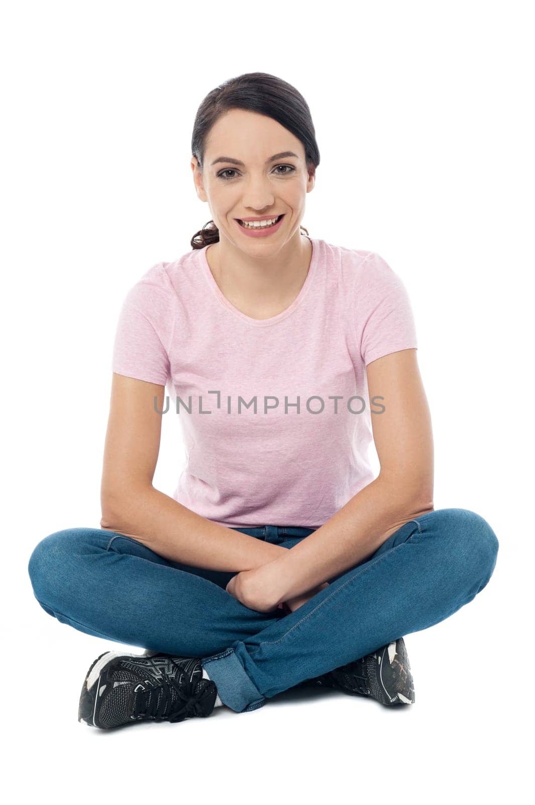 Happy young lady sitting with crossed legs