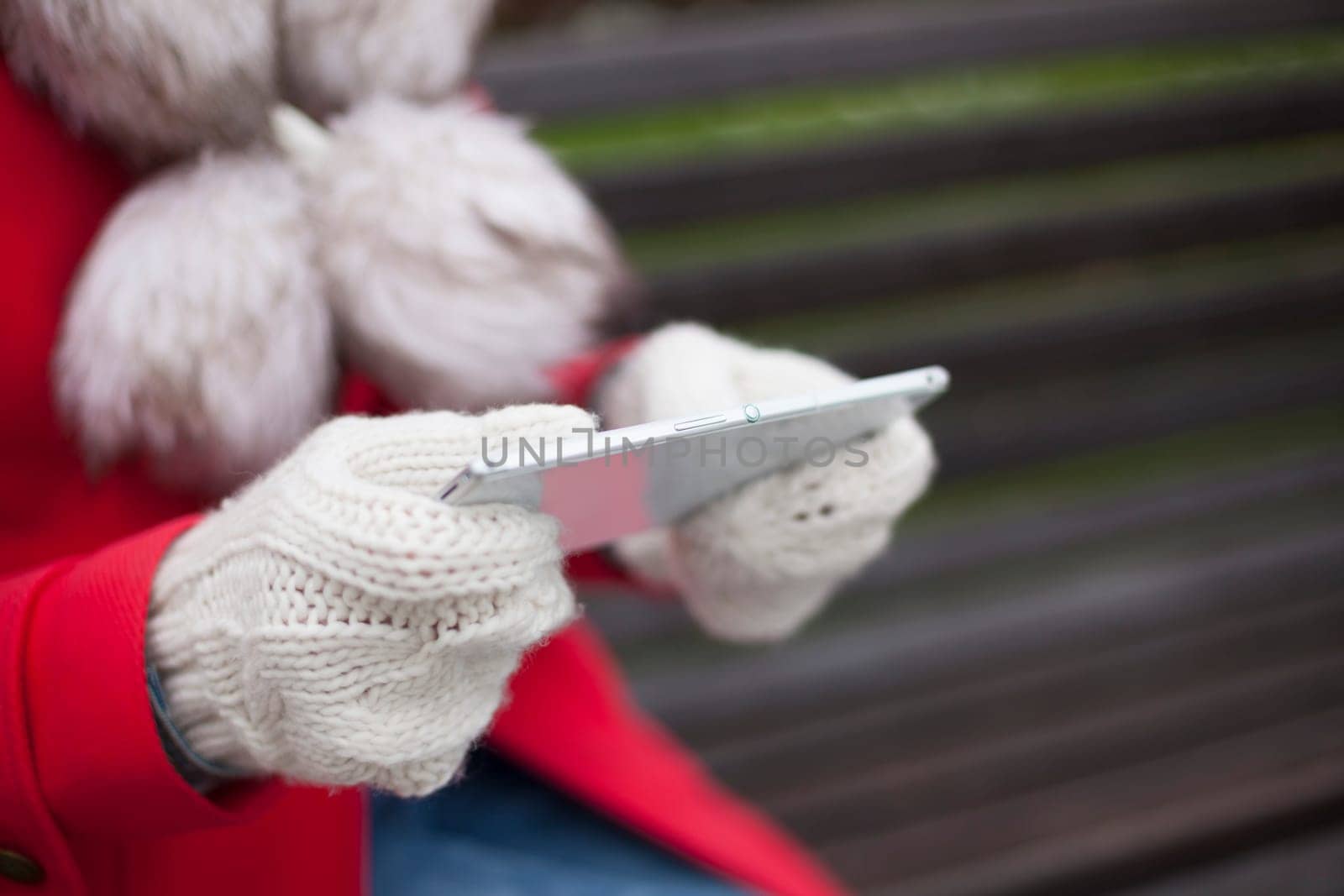 Traveling woman with mobile phone, cold weather