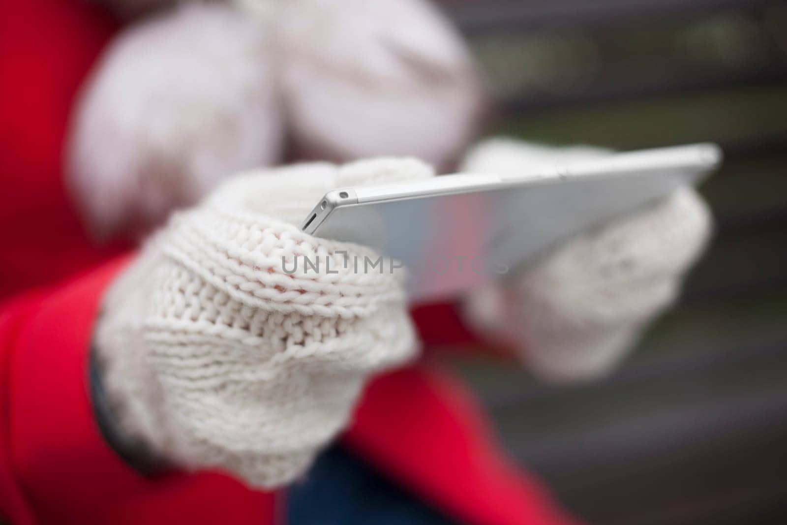 Traveling woman with mobile phone, cold weather