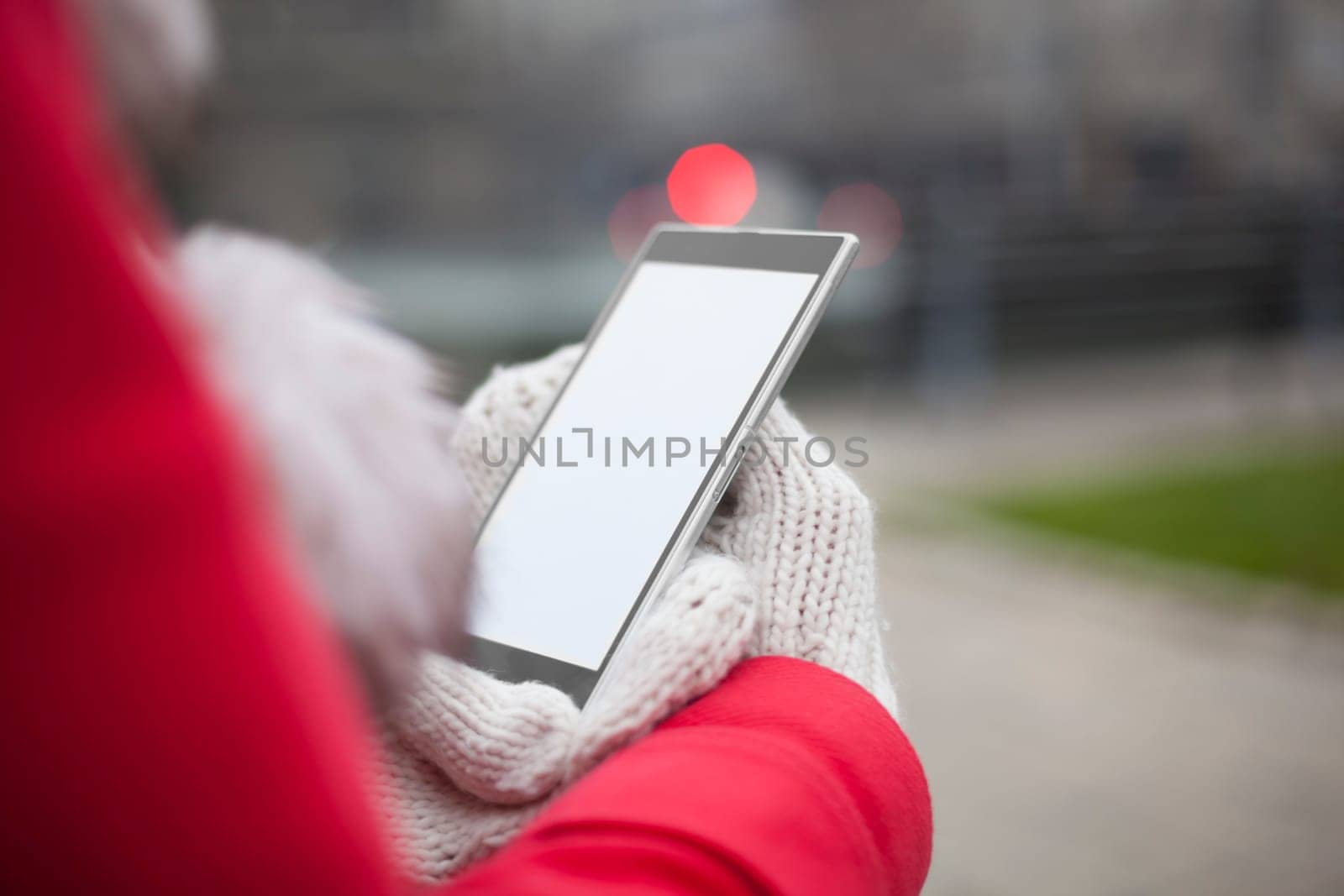Traveling woman with mobile phone, cold weather