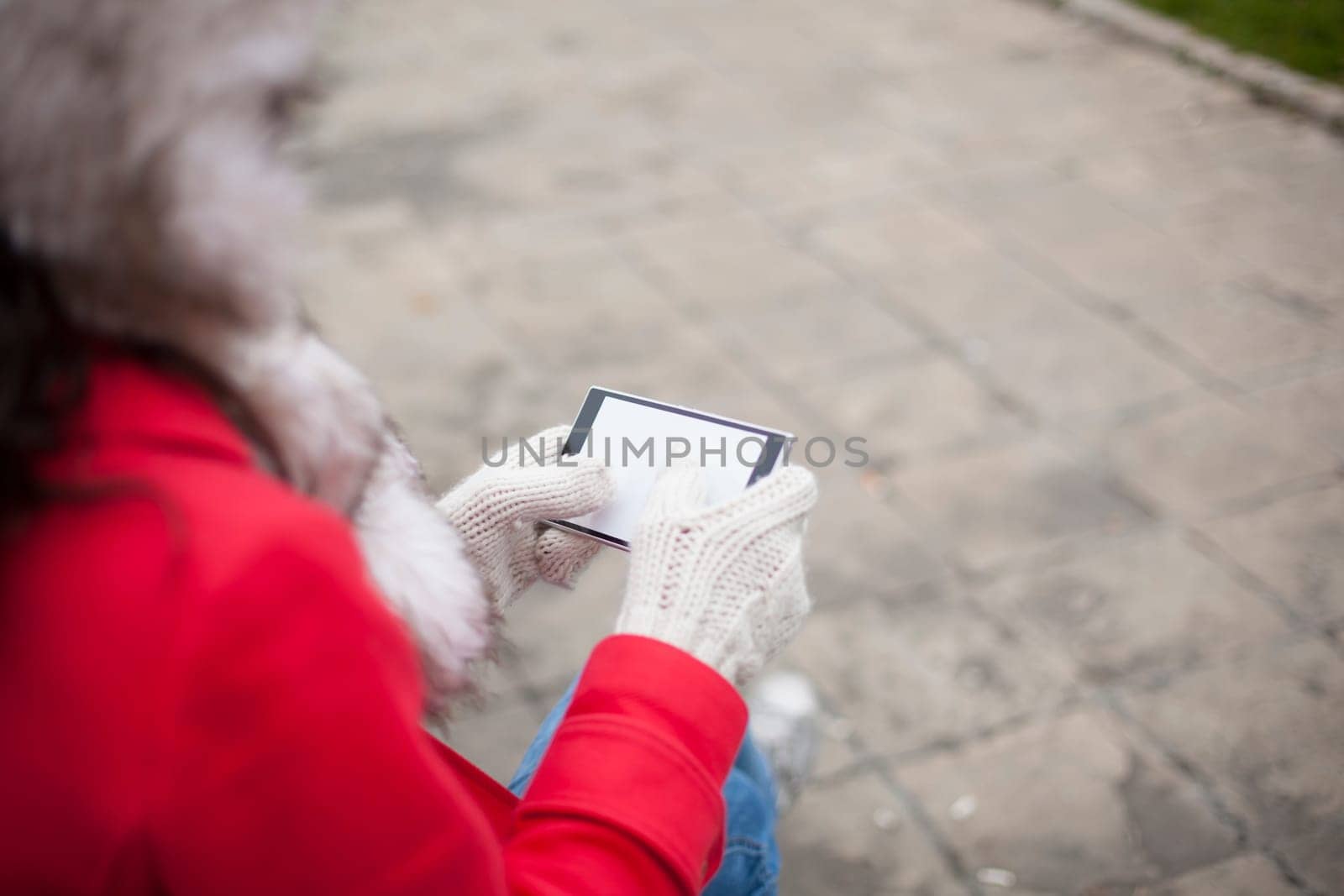 Traveling woman with mobile phone, cold weather