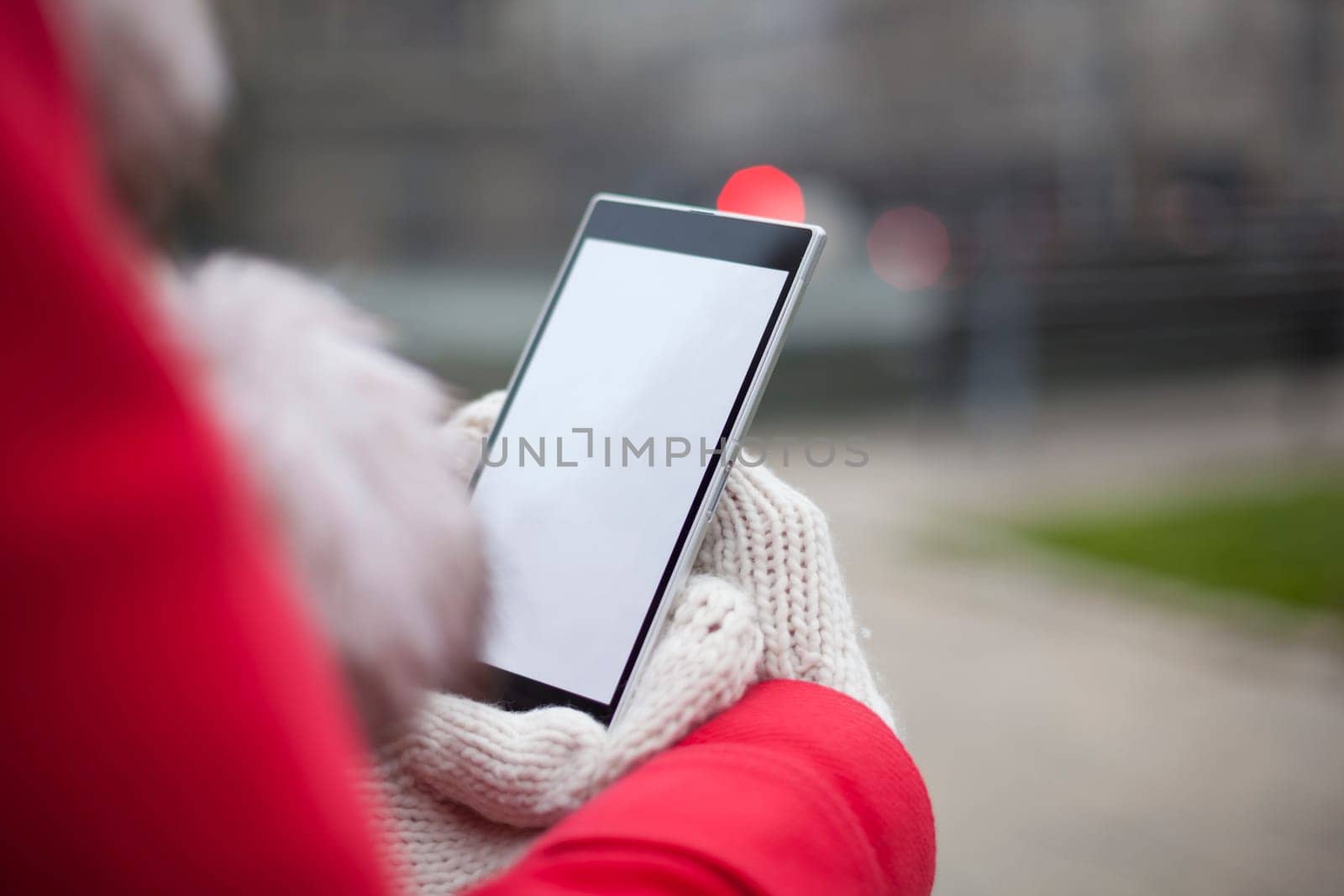 Traveling woman with mobile phone, cold weather
