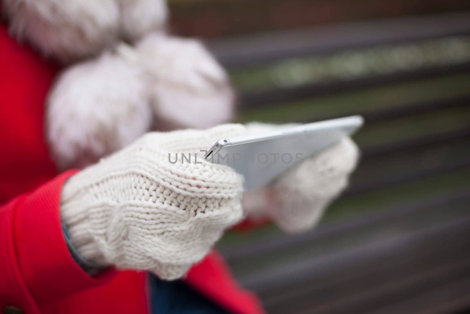 Traveling woman with mobile phone, cold weather