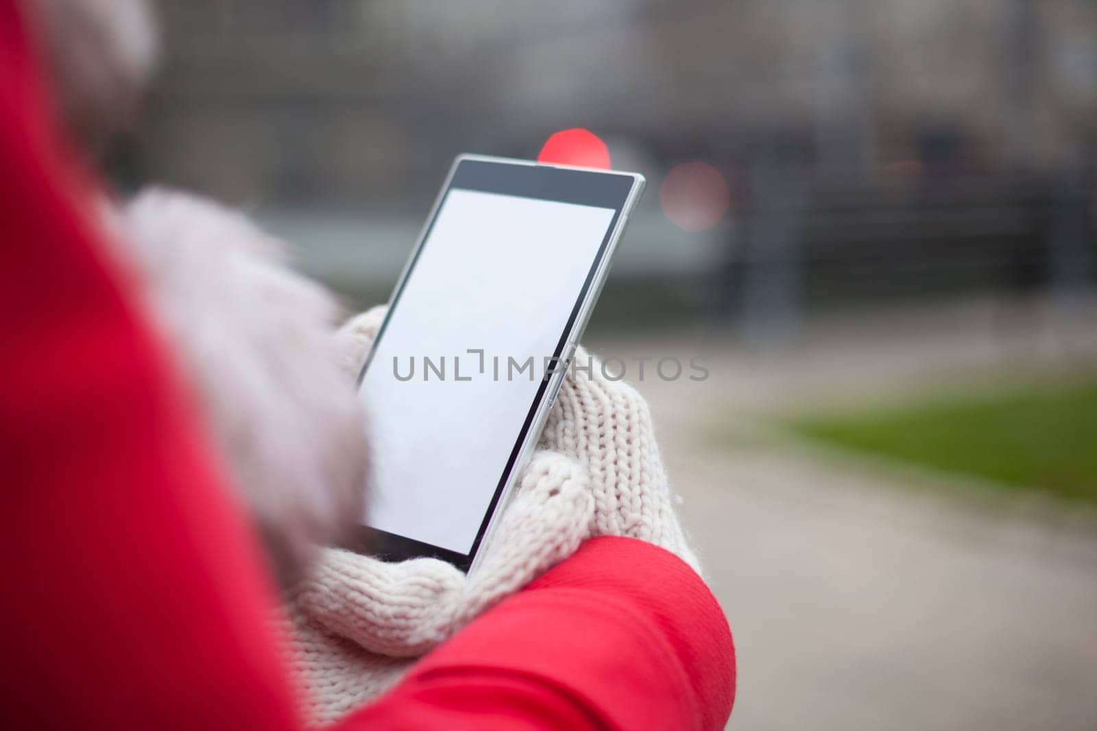 Traveling woman with mobile phone, cold weather