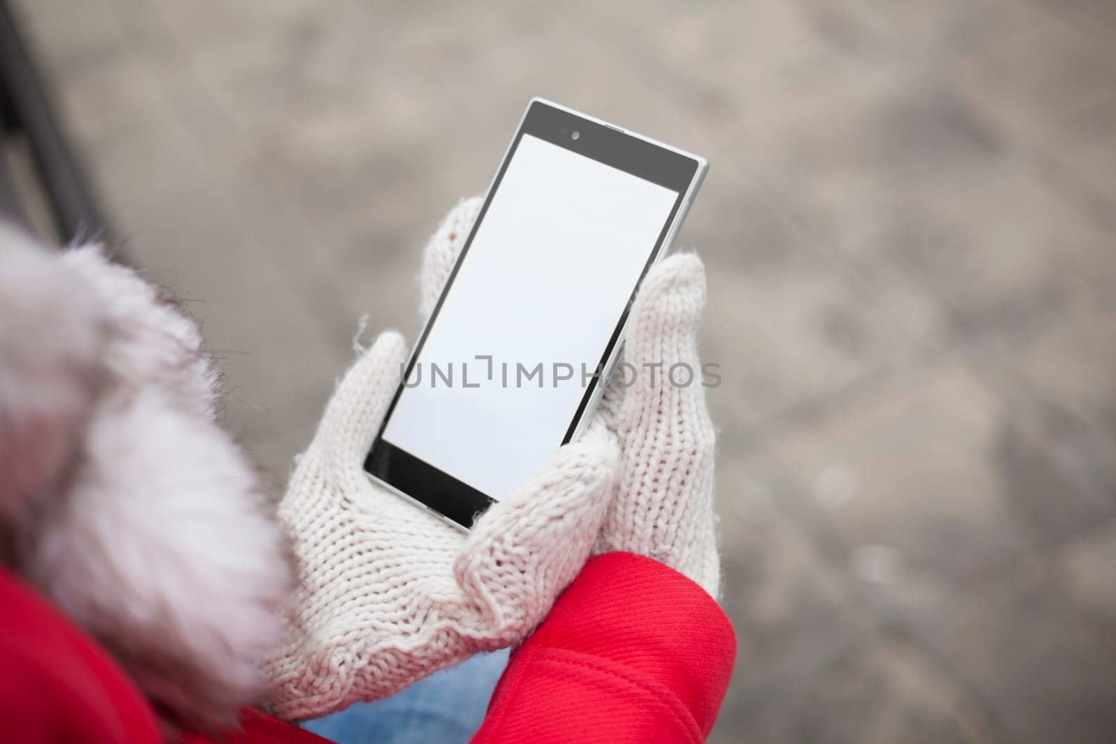 Traveling woman with mobile phone, cold weather