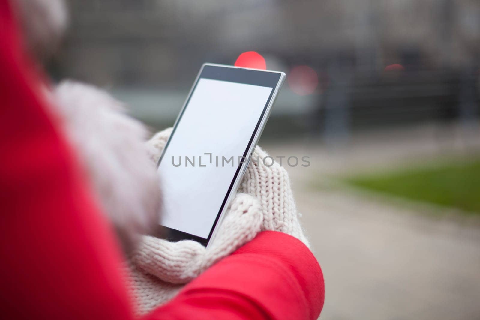 Traveling woman with mobile phone, cold weather