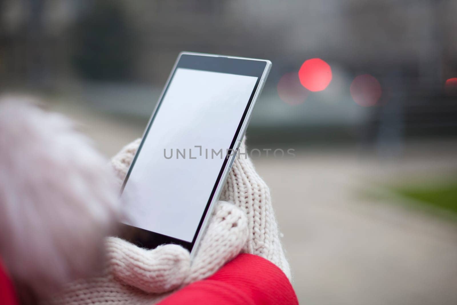 Traveling woman with mobile phone, cold weather