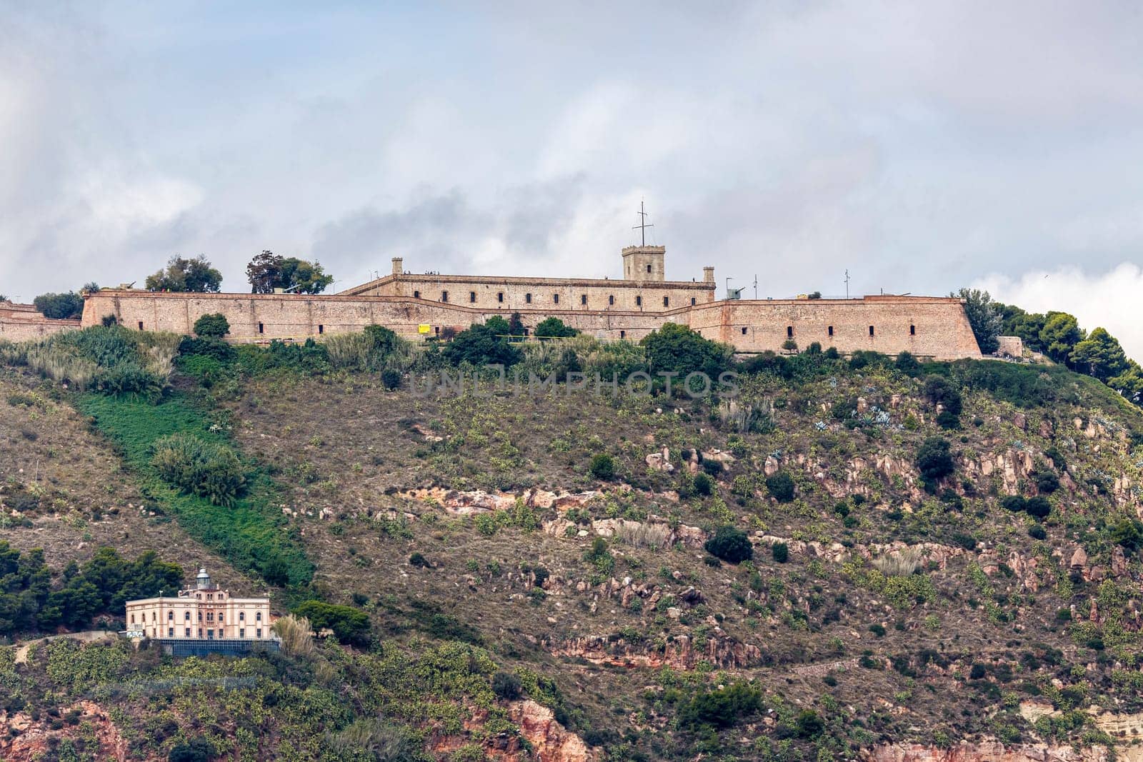 View of Castillo de Montjuic and lighthouse on mountain Montjuic in Barcelona, Spain
