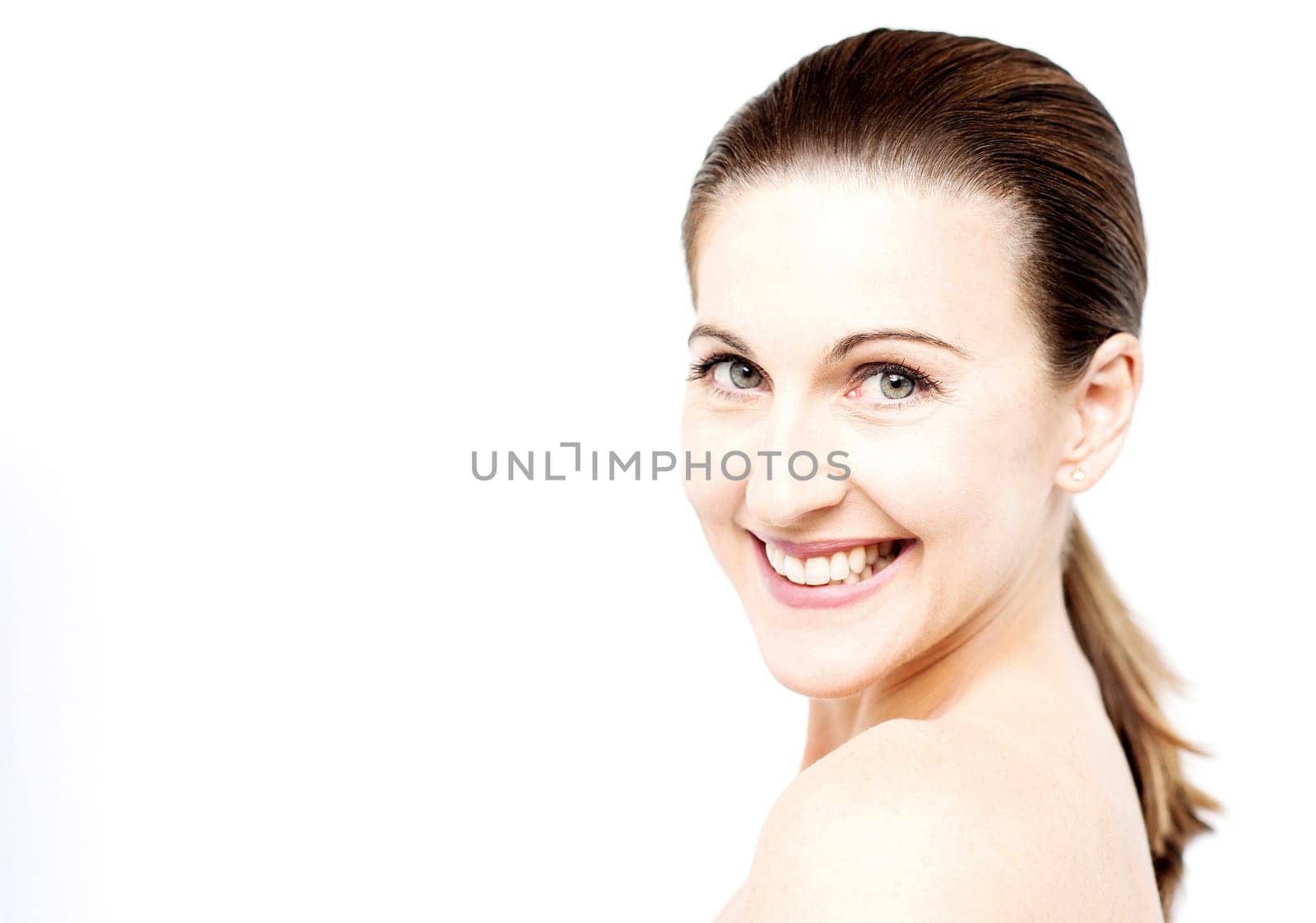 Smiling woman posing over shoulders to camera