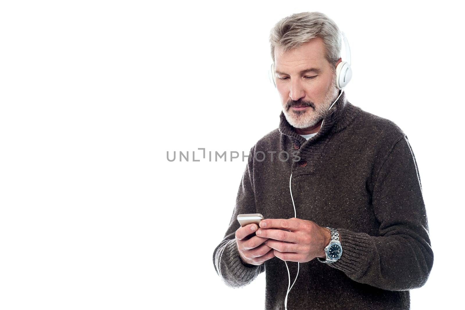 Senior man listening music on his cell phone