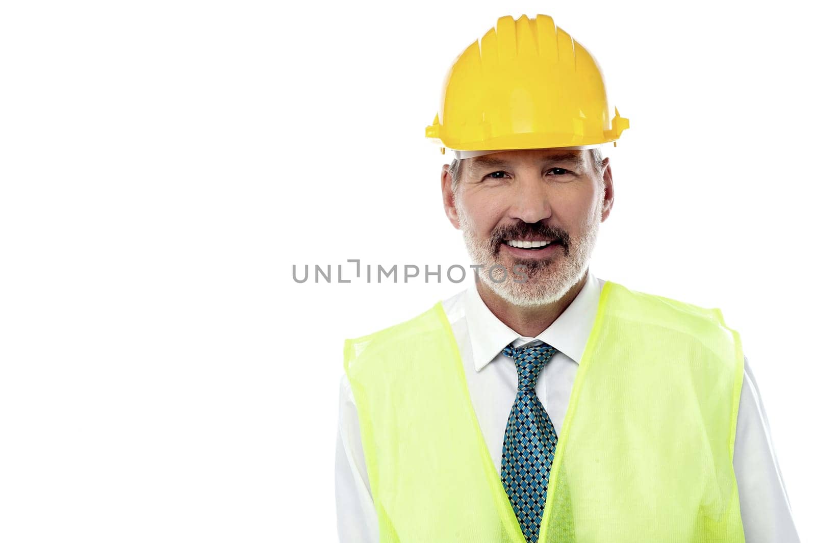 Senior construction engineer posing against white background