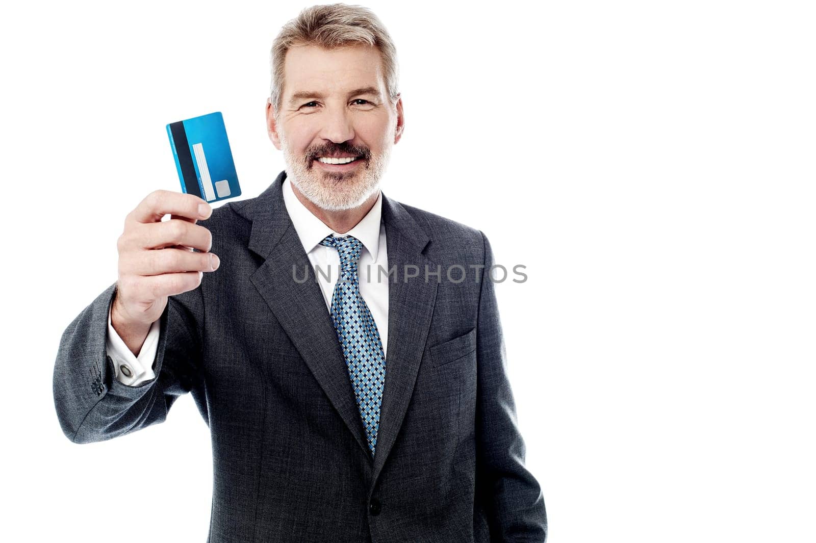 Smiling male executive displaying credit card over white