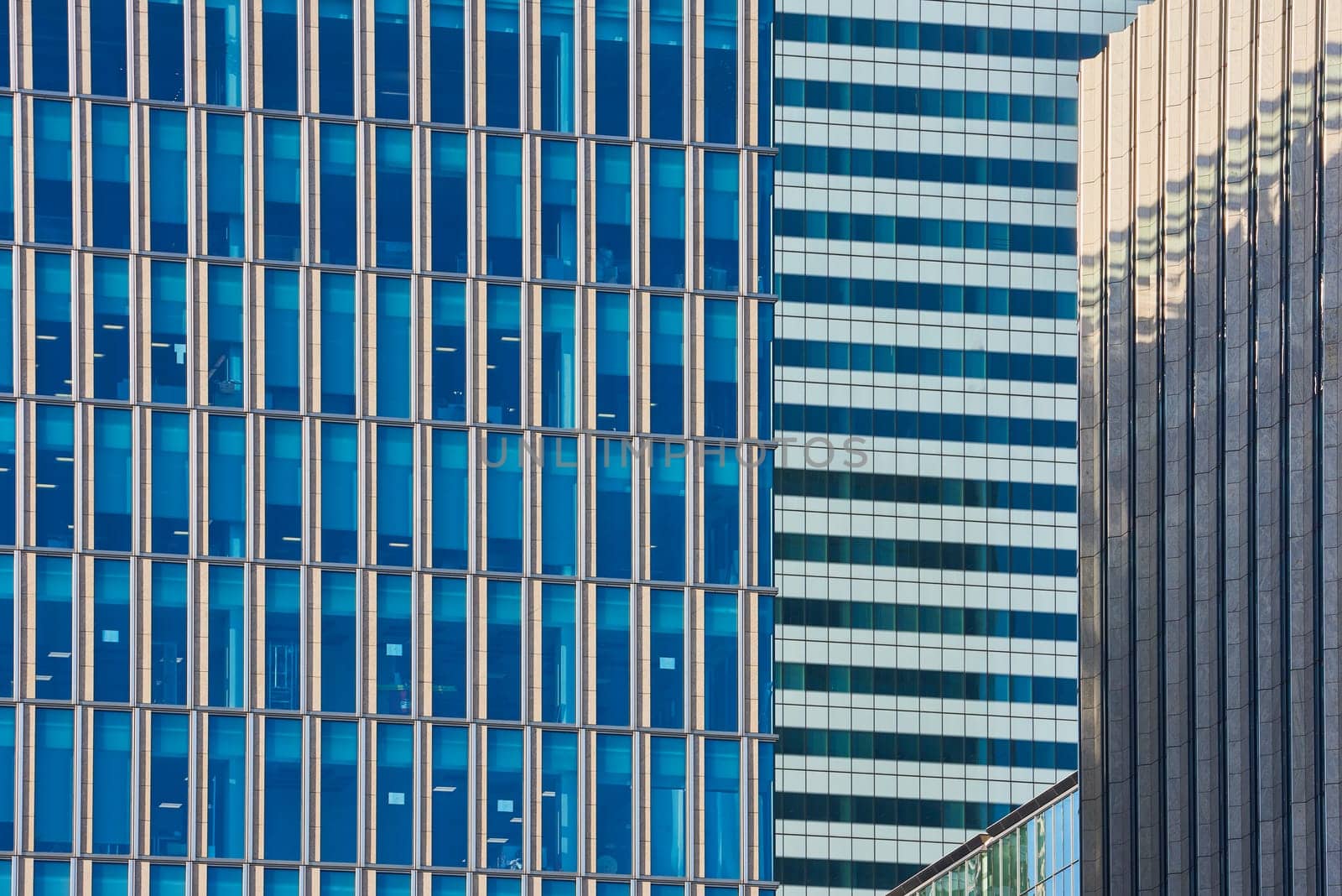 Close up cropped shot of skyscraper window frames in blue metal.