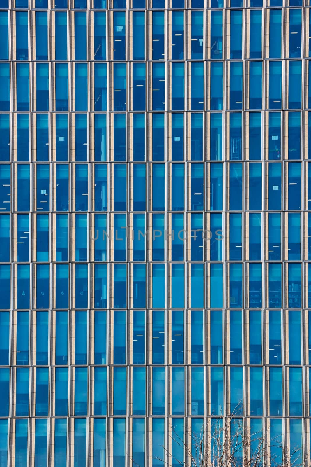 Close up cropped shot of skyscraper window frames in blue metal.