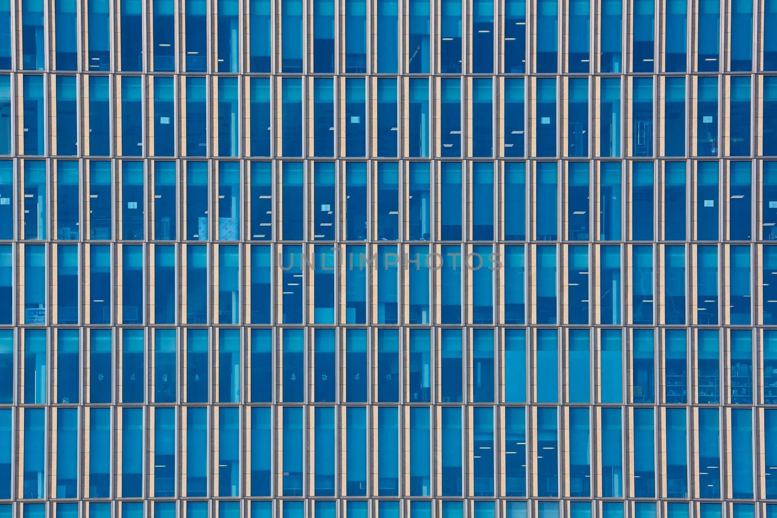 Close up cropped shot of skyscraper window frames in blue metal.