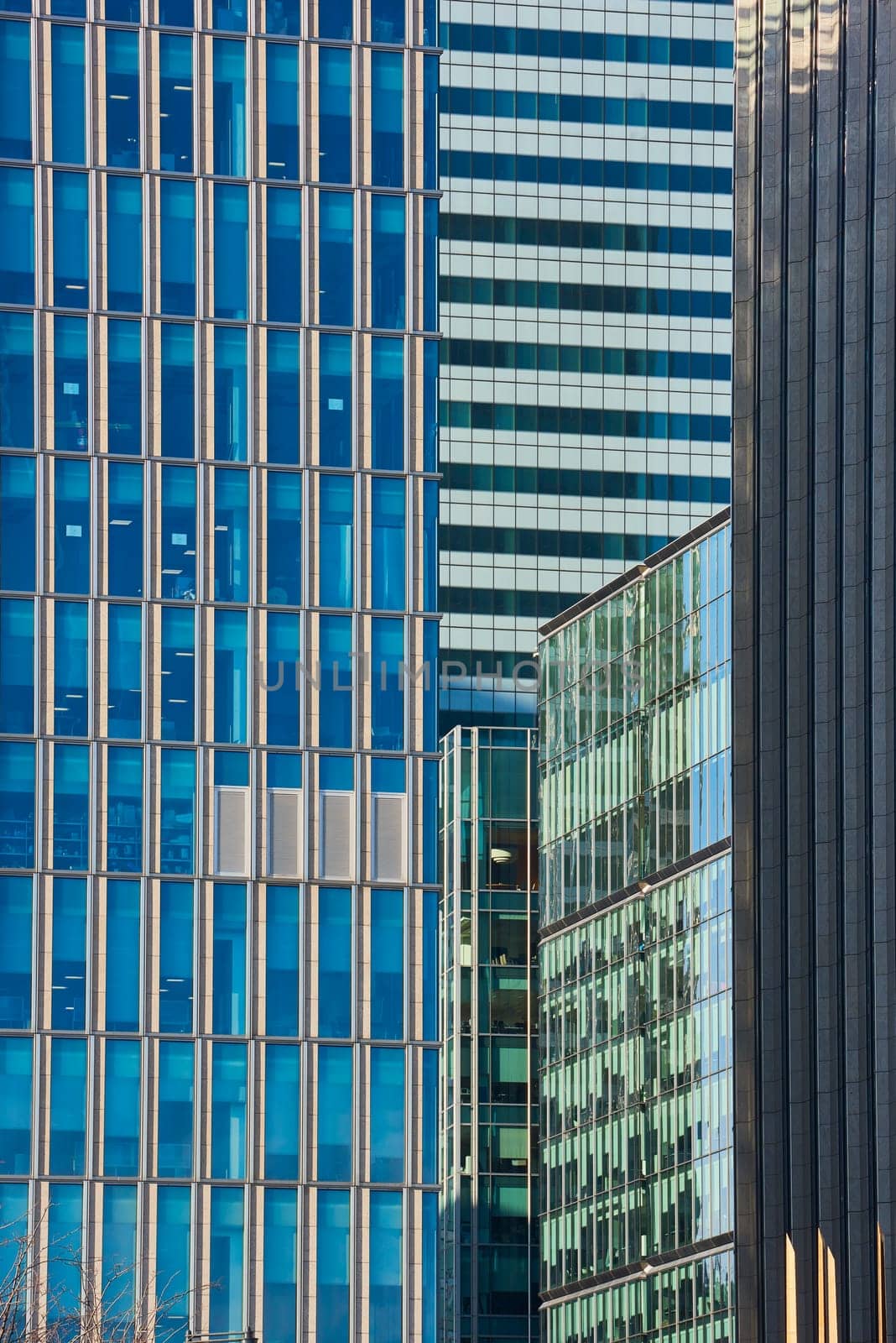 Close up cropped shot of skyscraper window frames in blue metal.
