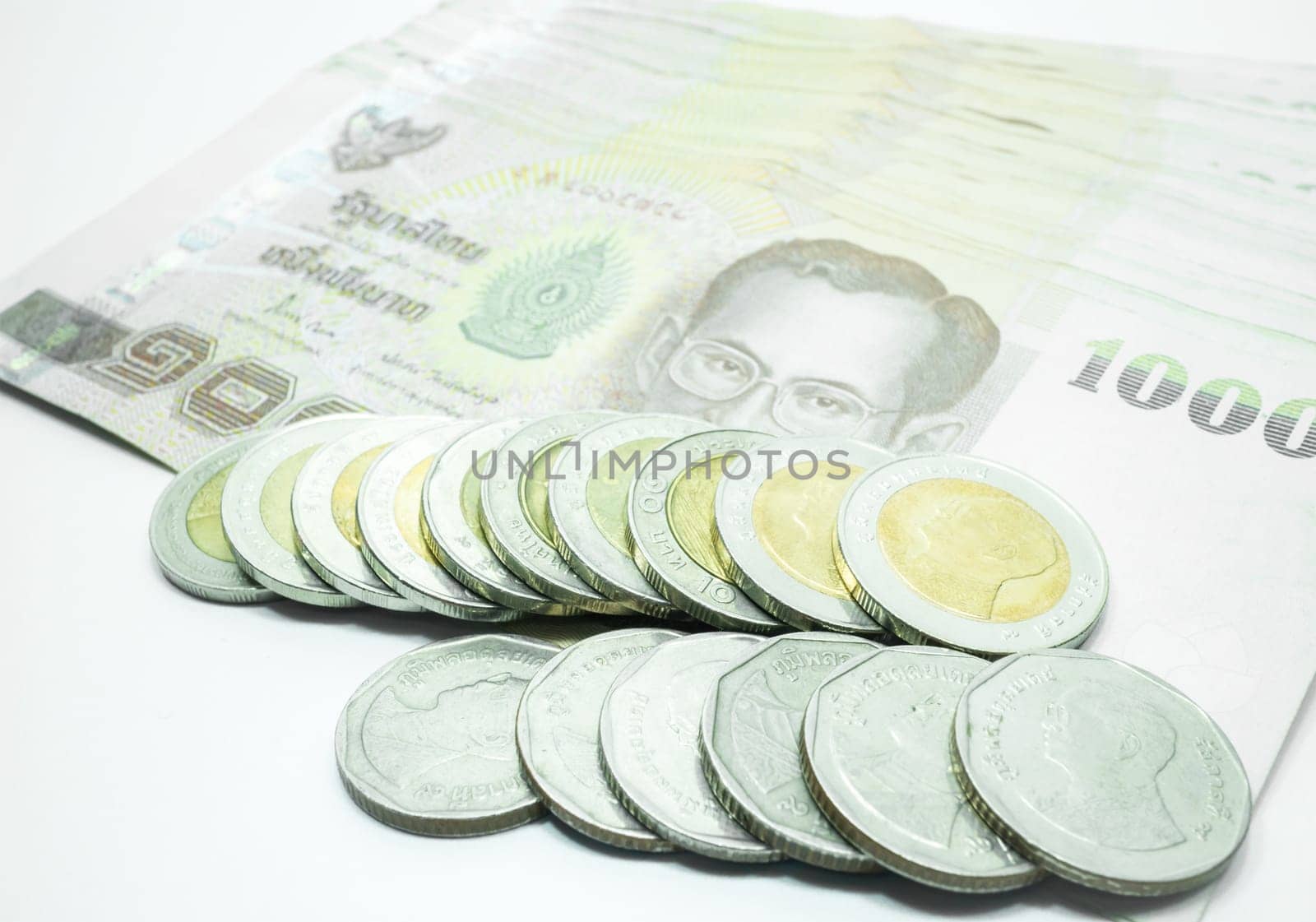 Thai banknote and coin on white background, stock photo