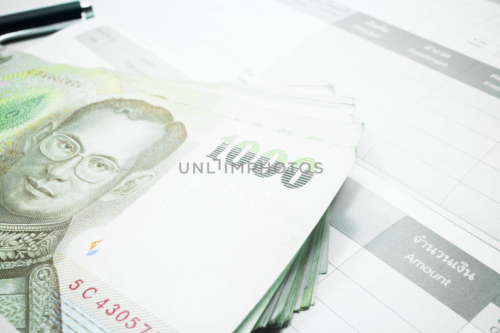 Thai money banknote on record table note book, stock photo