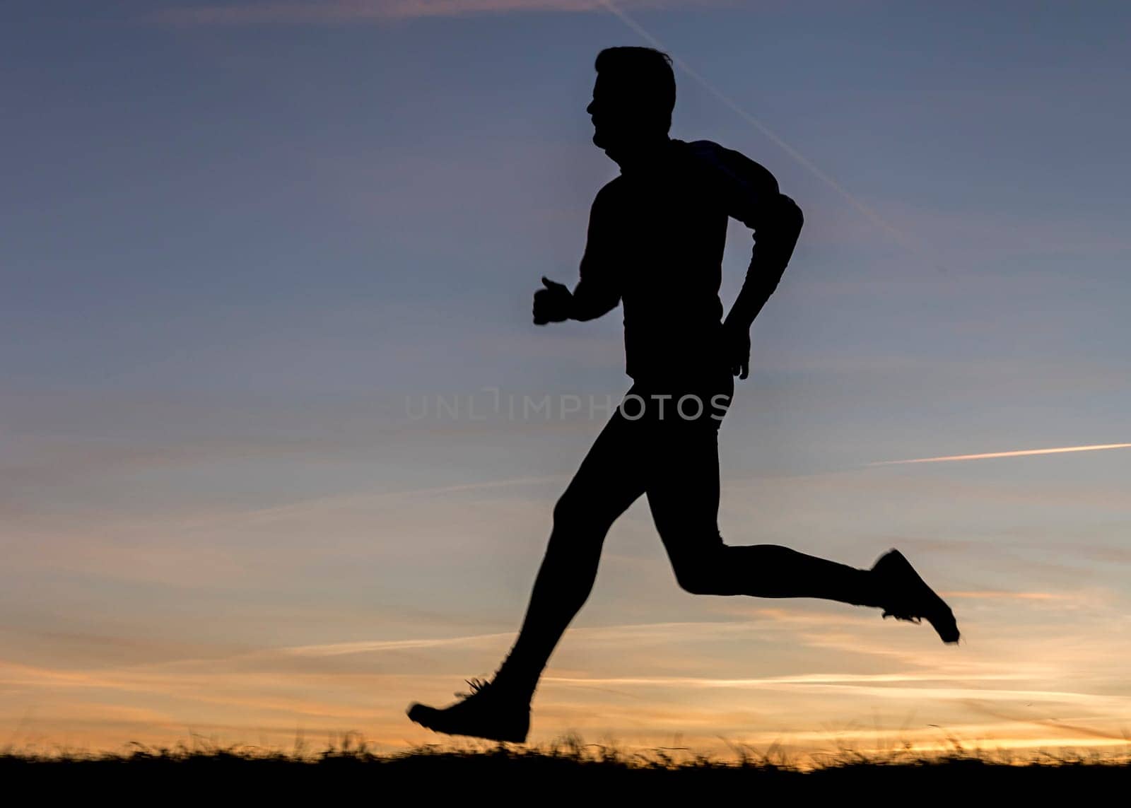 silhouette of a jogger at sunset