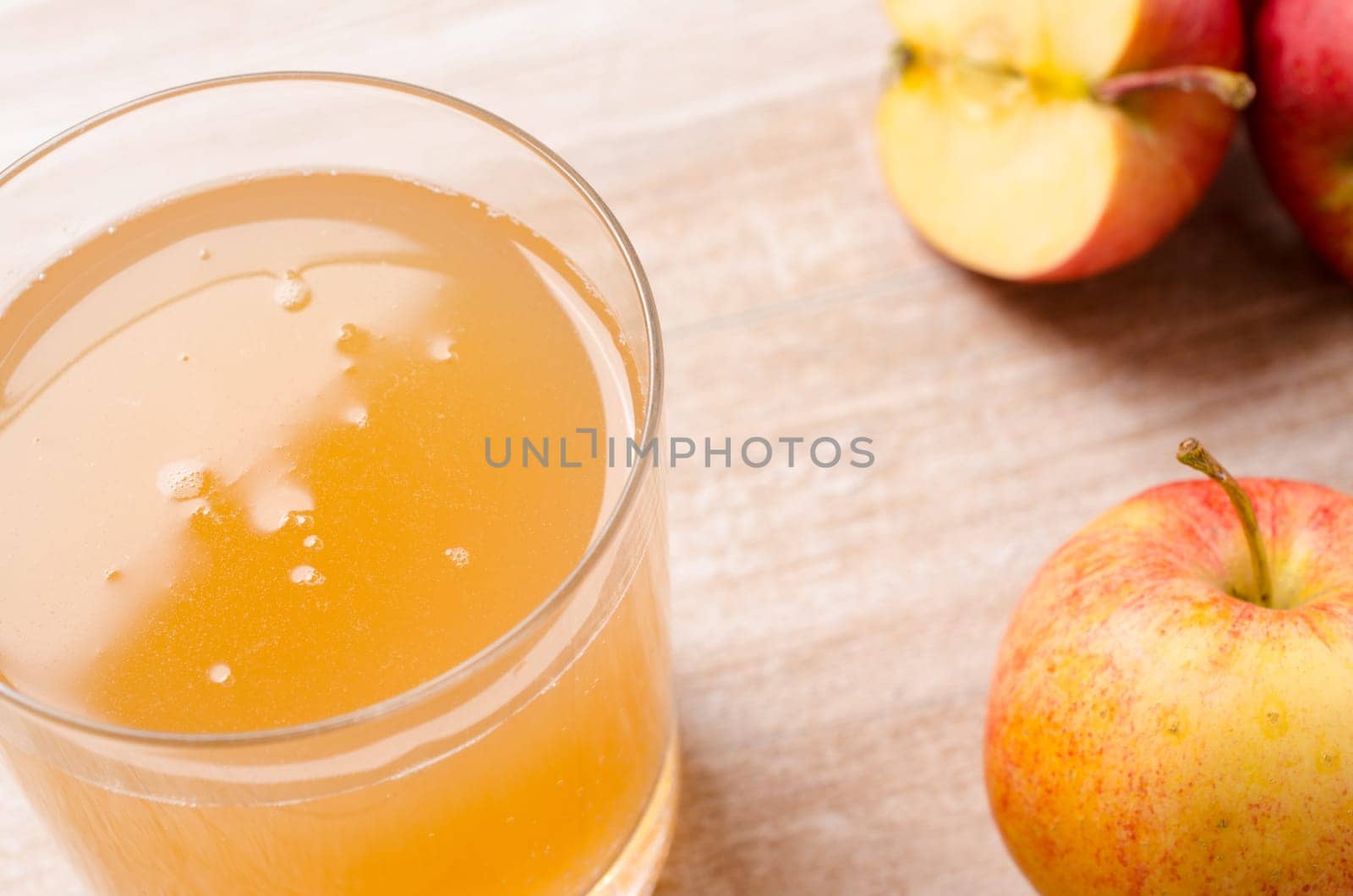 Organic apple juice with fresh apples on a wooden table