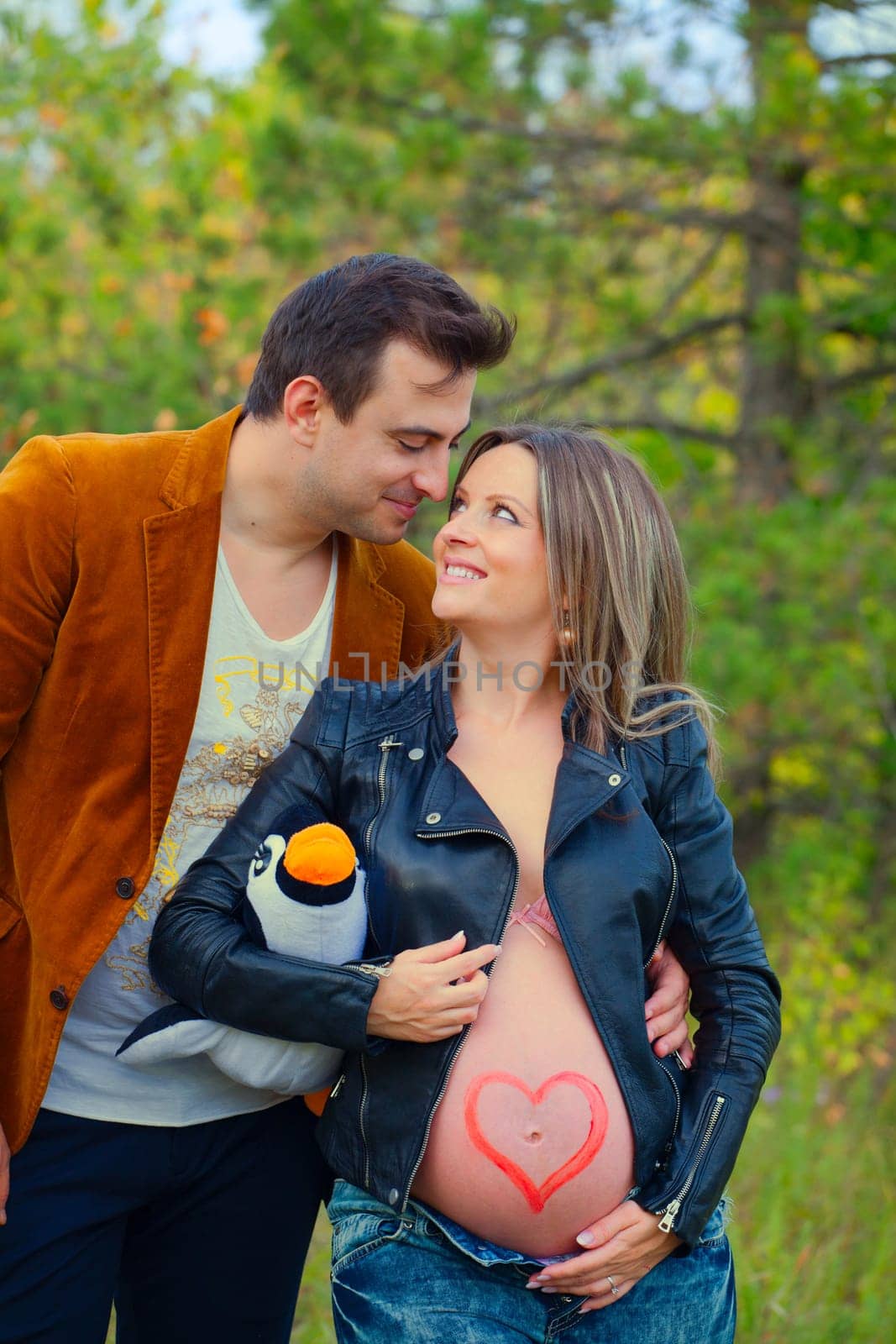 Pregnant woman with her husband relaxing outdoor.